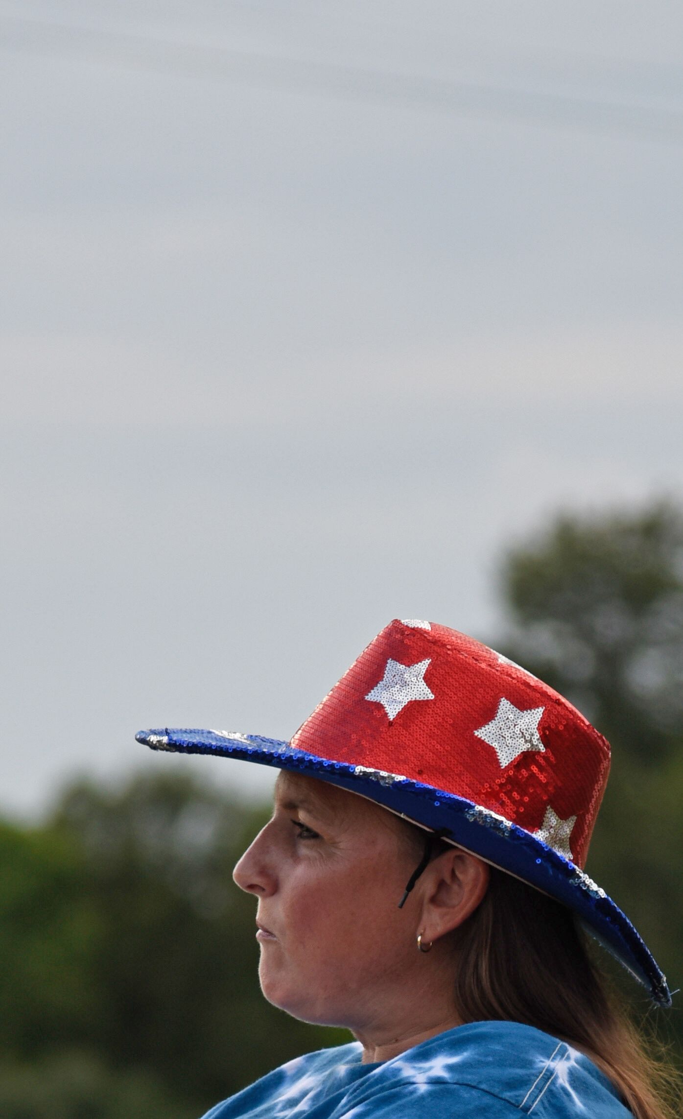 A woman wears a Stars and Stripes glitter hat at the Presidential Debate Watch Party in Ashland.