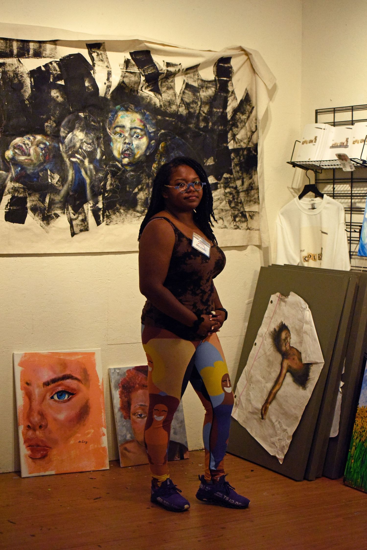 Asia Long stands in her studio in front of her artwork Friday at Orr Street Studios in Columbia.