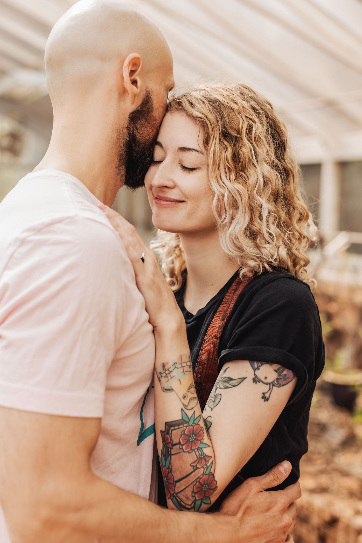 A couple sharing intimate moments in a sequence of romantic outdoor photos showing their visible arm tattoos.
