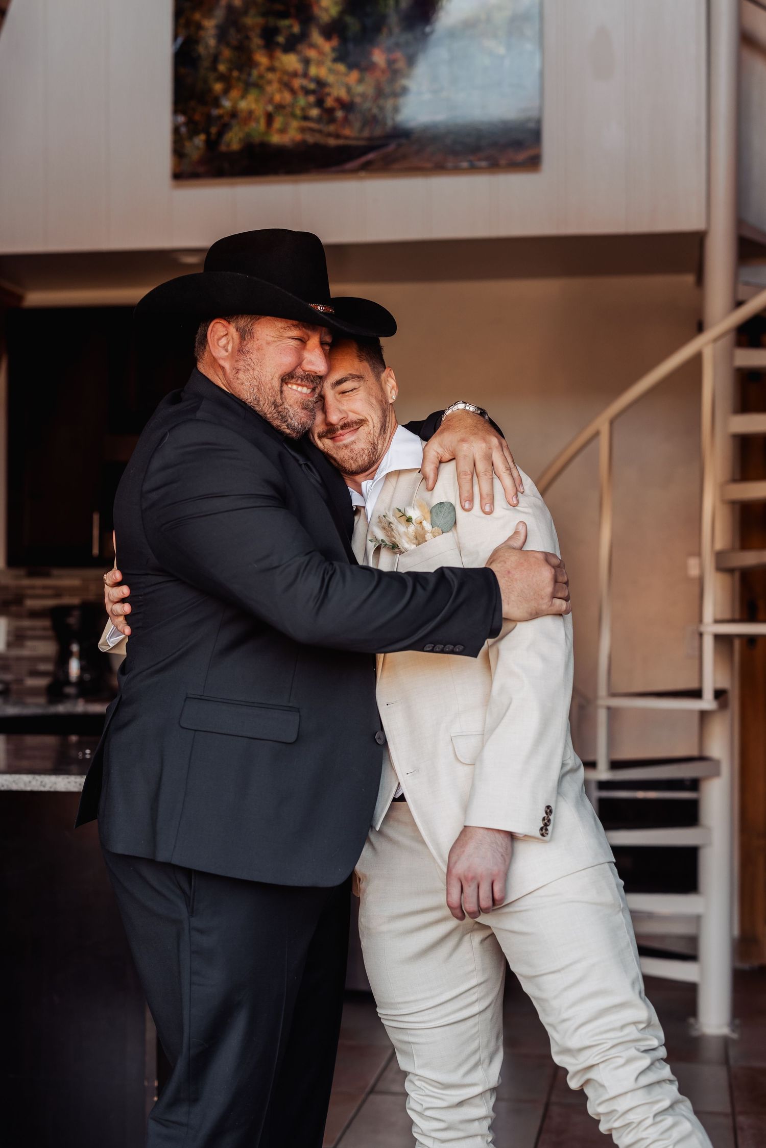 A series of emotional embraces between two people in formal attire at an indoor venue.