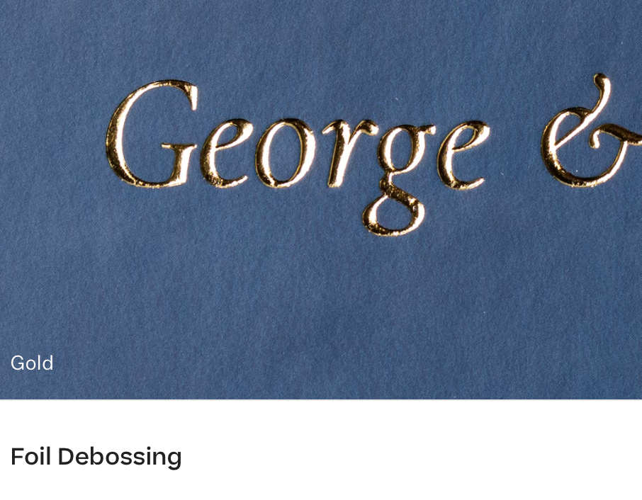 Gold embossed text reading 'George &' on a blue background showing foil debossing technique.