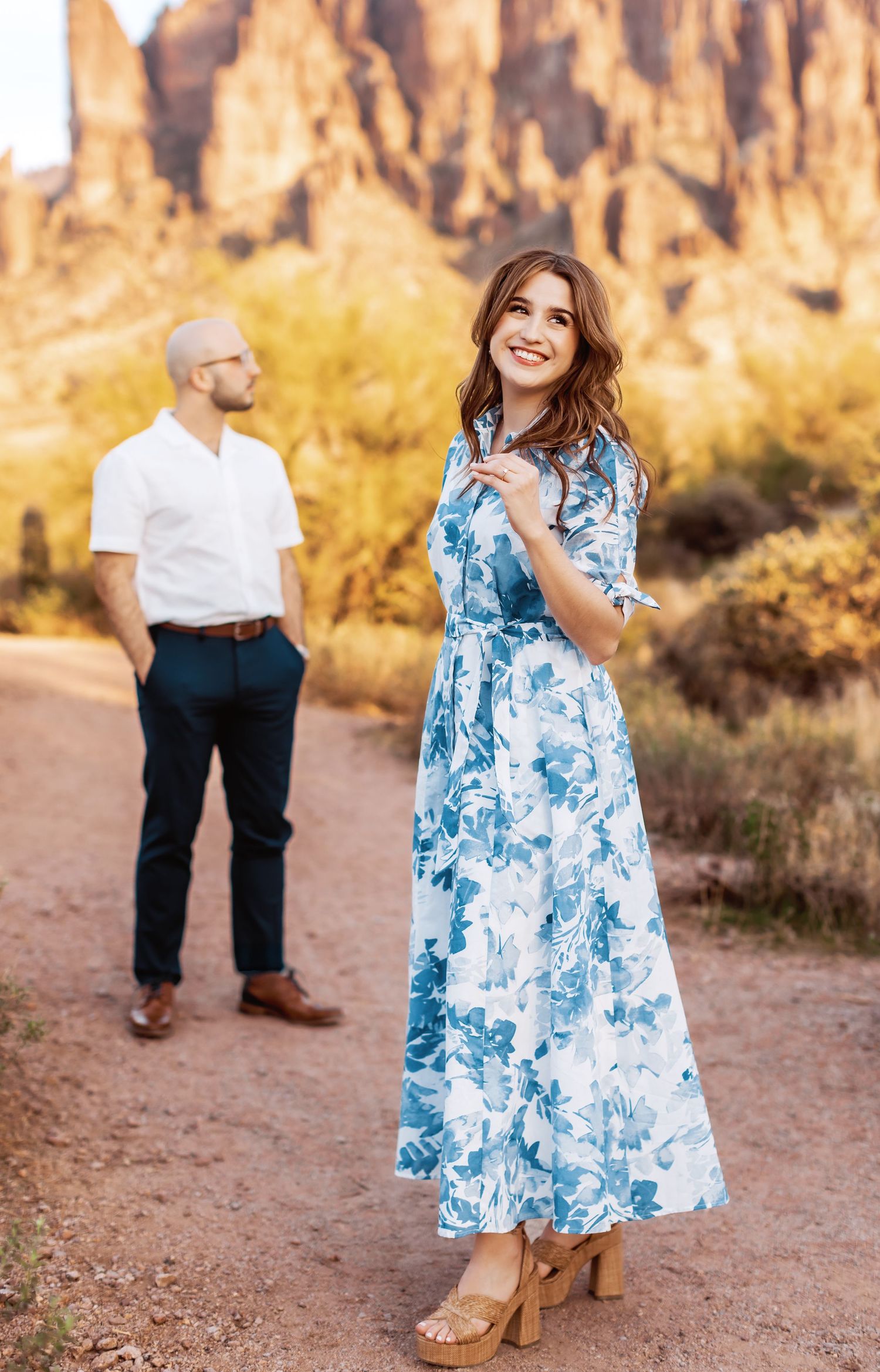 Romantic desert photoshoot with dramatic red rock formations in the background.