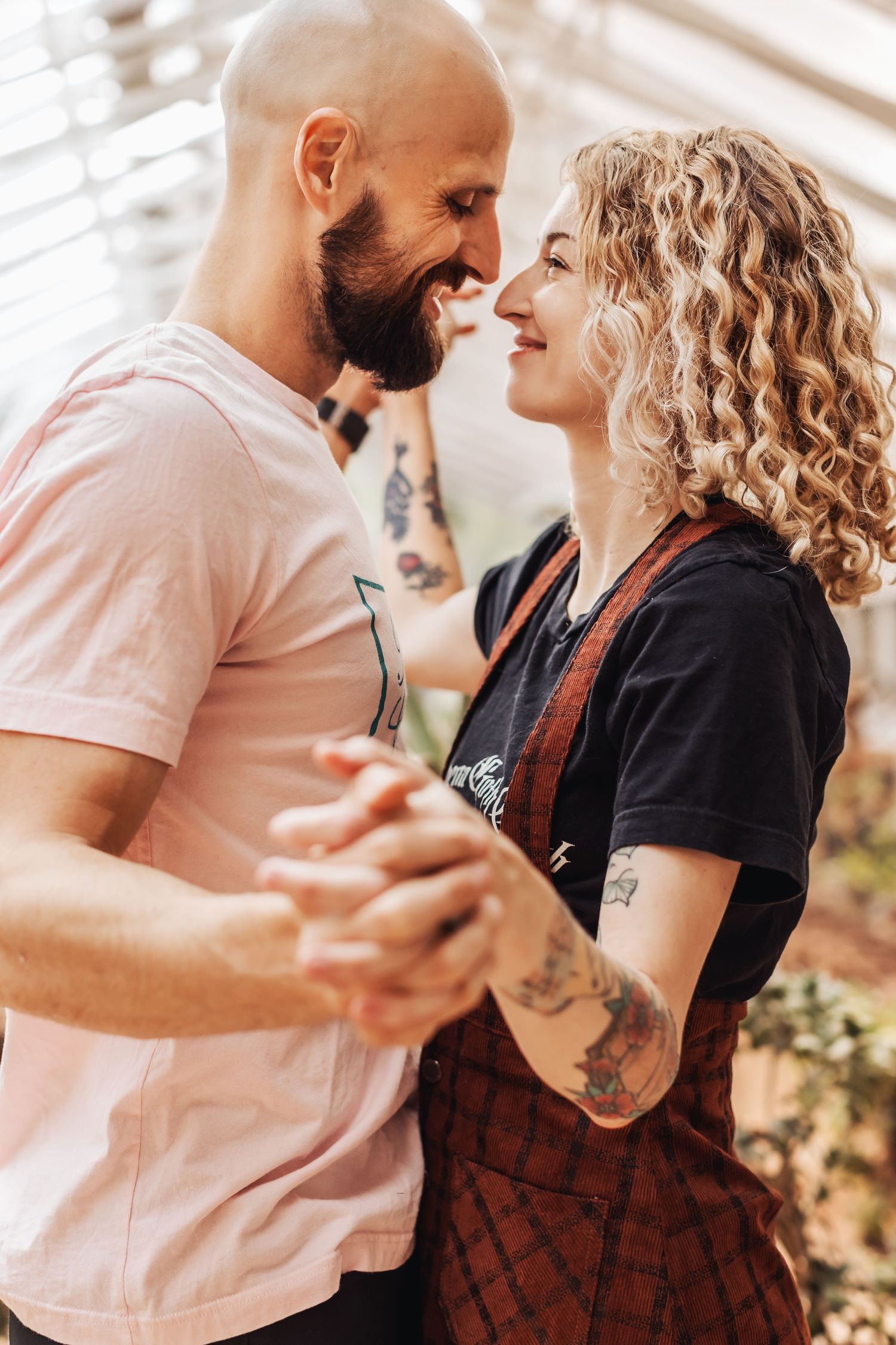 A couple shares intimate dancing moments in warm lighting as they move together through a romantic sequence of poses.