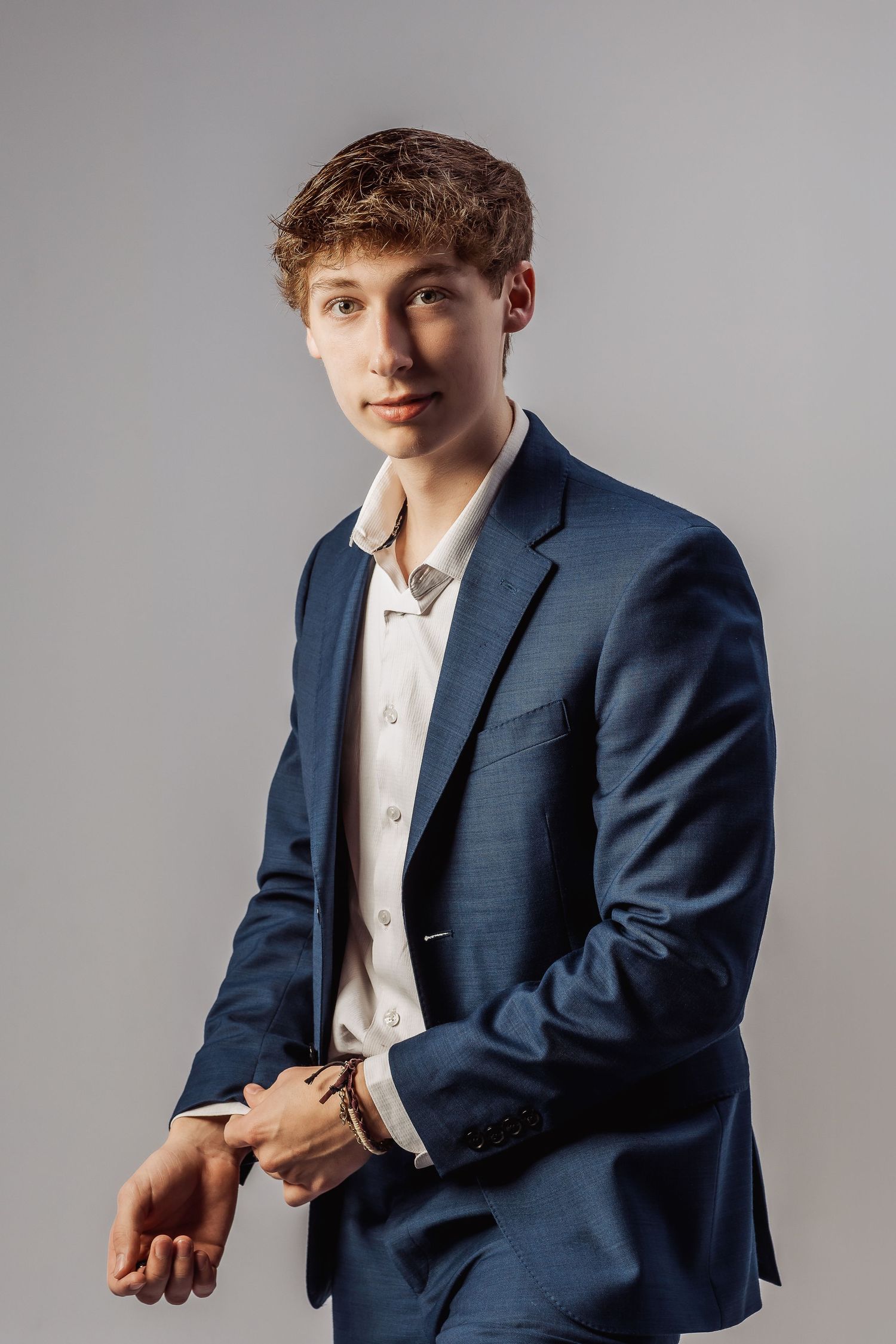Fashion portrait series featuring casual poses in a navy blazer and white shirt.