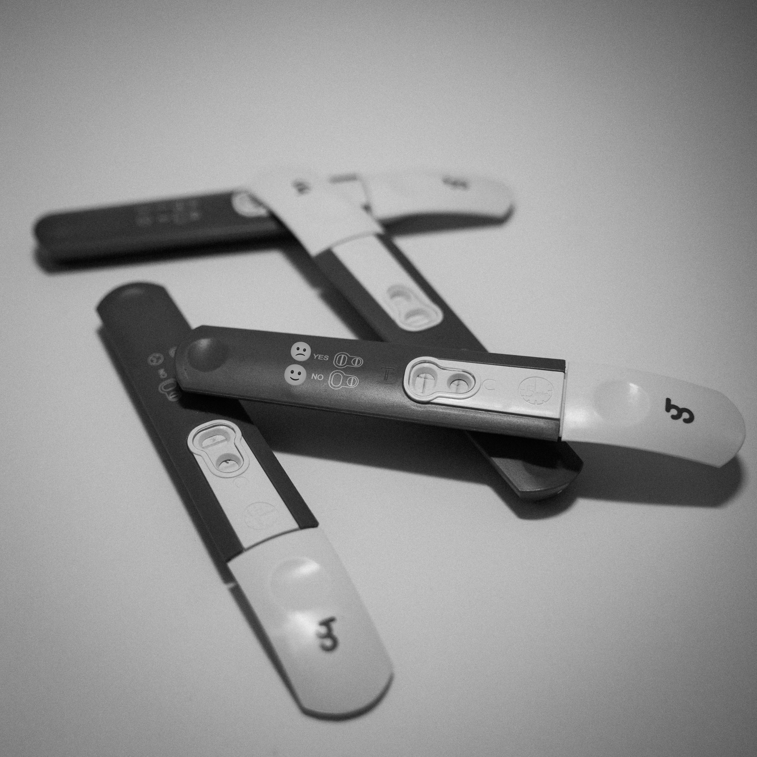 A black and white image sequence showing a USB flash drive on a reflective surface, captured from multiple angles.