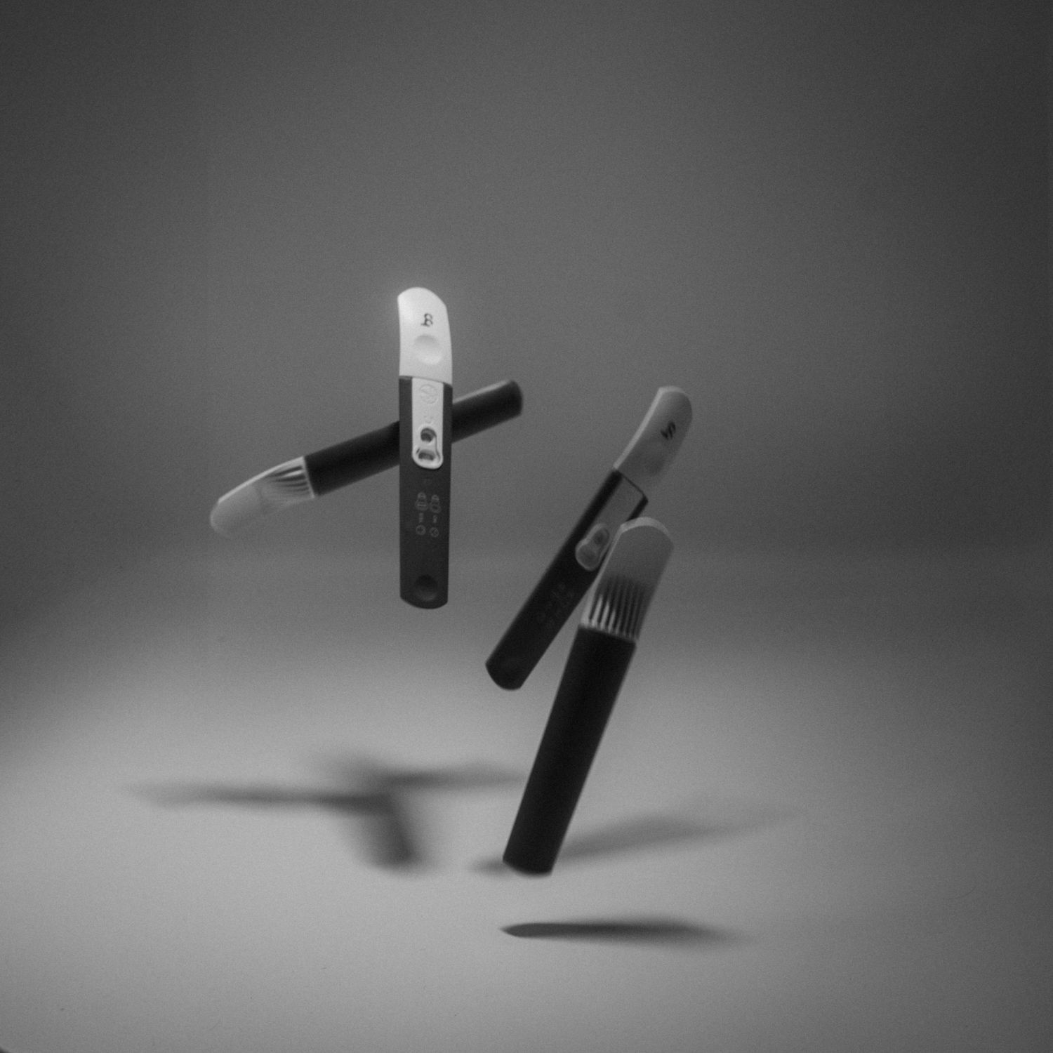 Black rubber band spinning and twisting to create dynamic motion effects against a gray background.