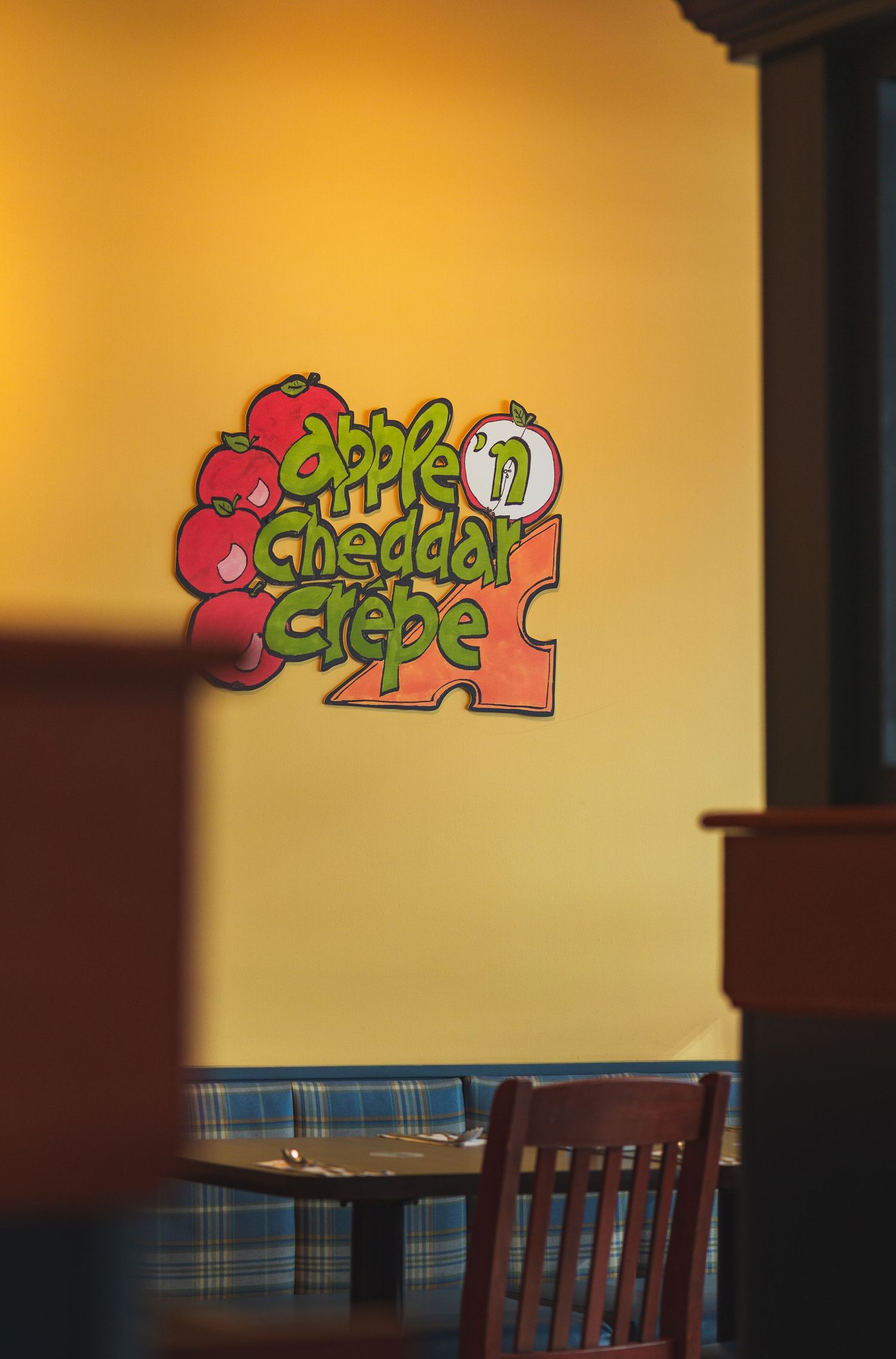 Warm and welcoming Cora’s breakfast spot with yellow-themed décor