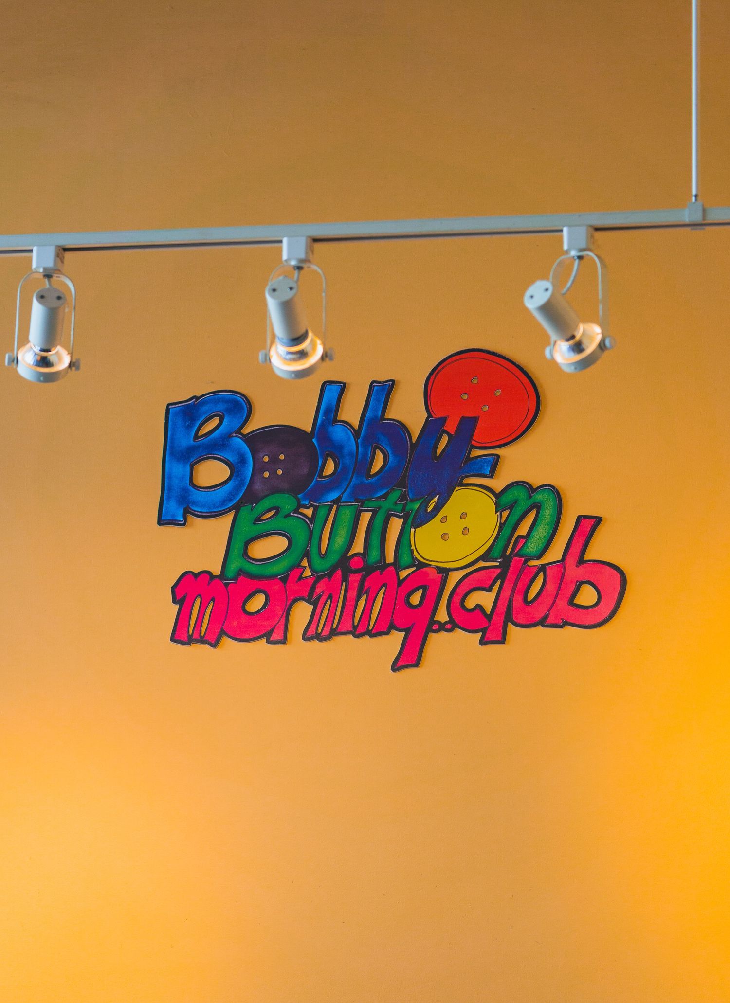 Playful quote signs on yellow walls inside Cora’s breakfast restaurant in Victoria, Canada