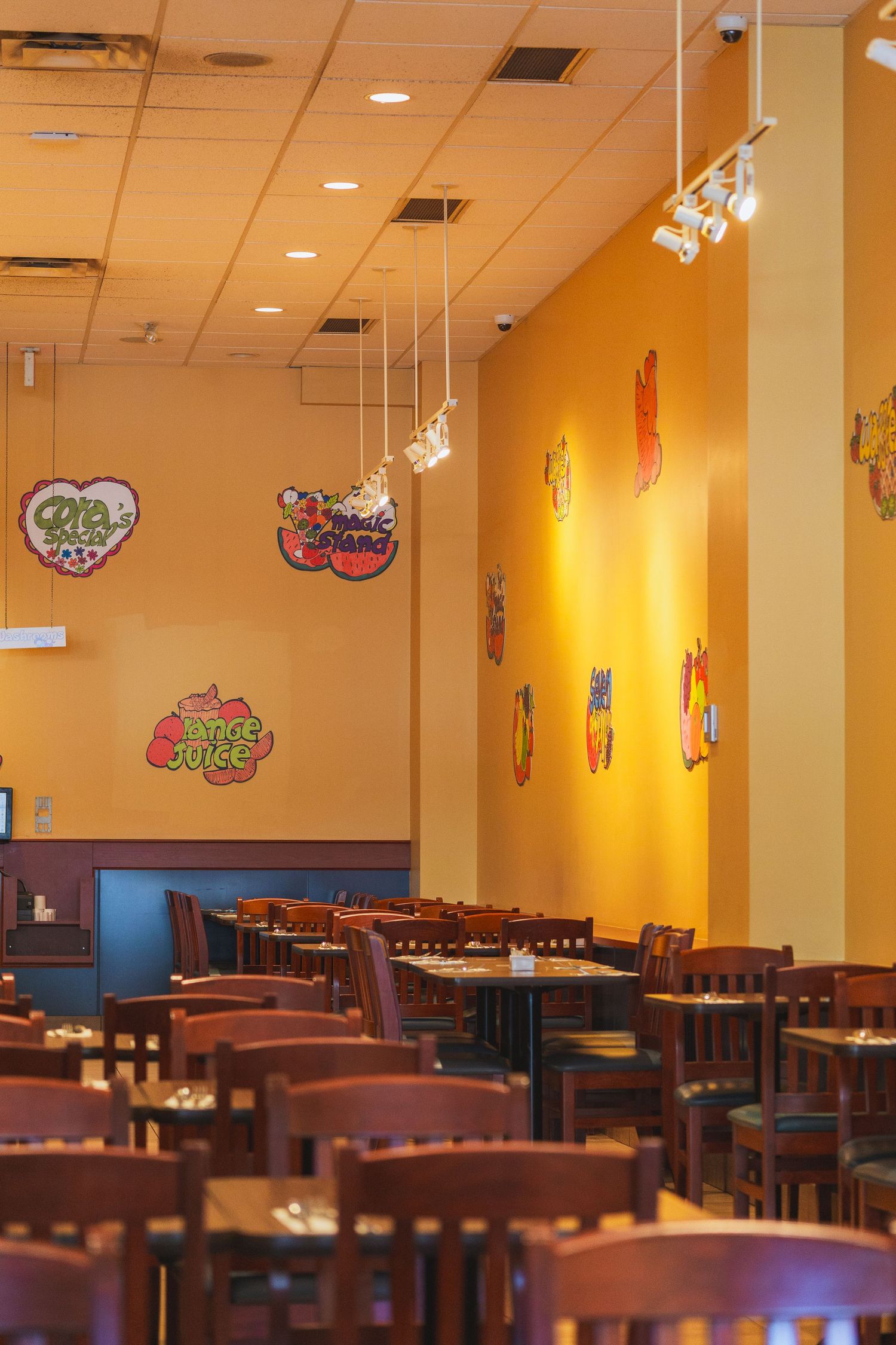 Bright and friendly interior of Cora’s highlighting yellow walls and breakfast tables in Victoria, Canada
