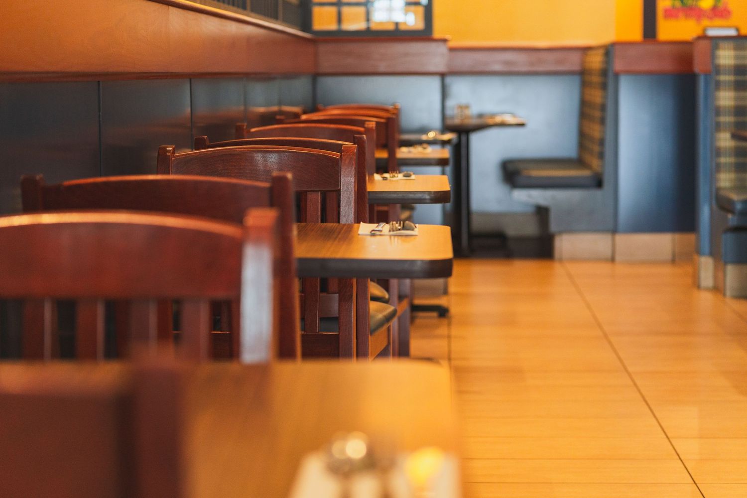 Vibrant Cora’s café-style interior featuring bold yellow walls and booth seating in Victoria, Canada