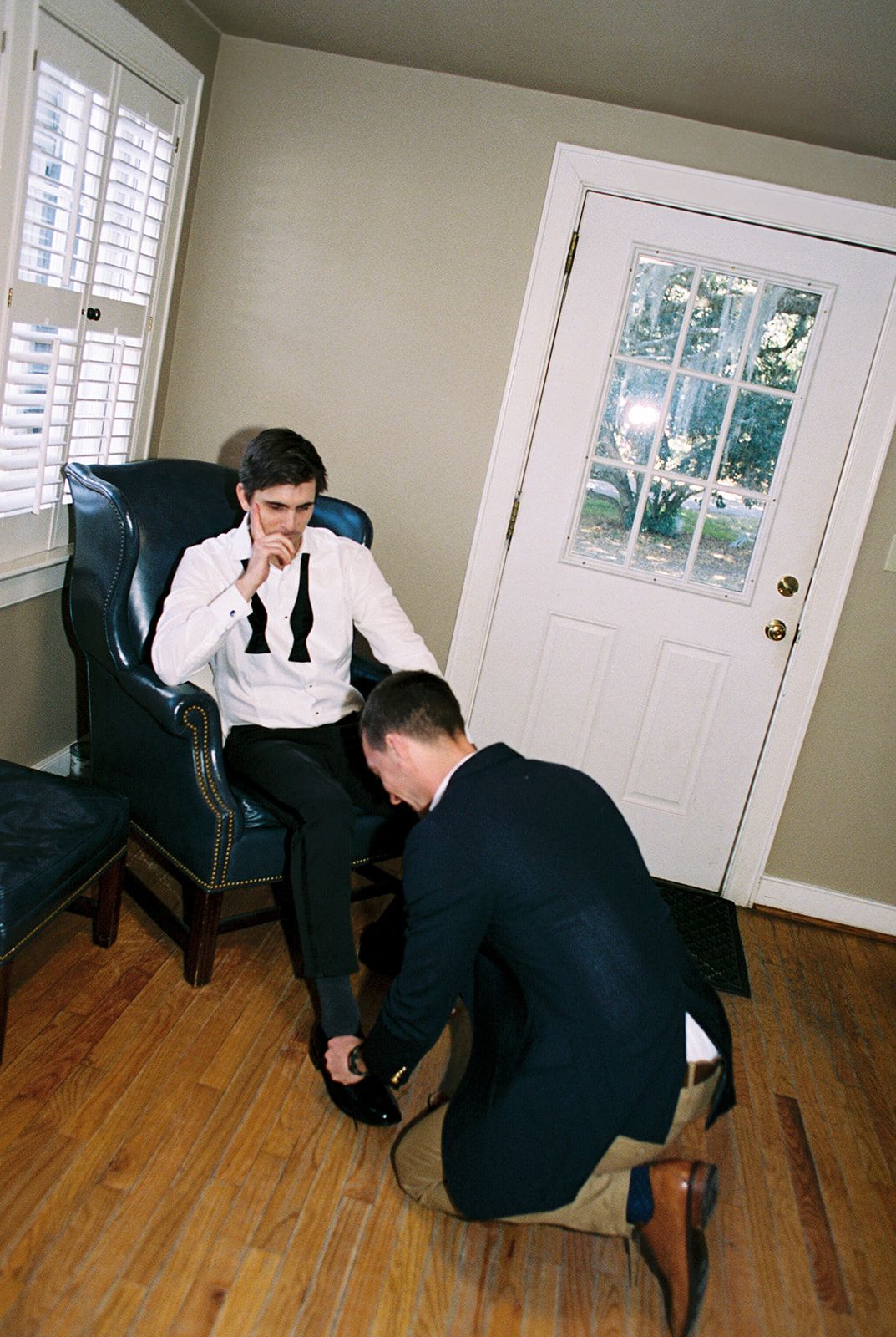 A series of photos showing two people practicing self-defense moves and techniques on a hardwood floor.