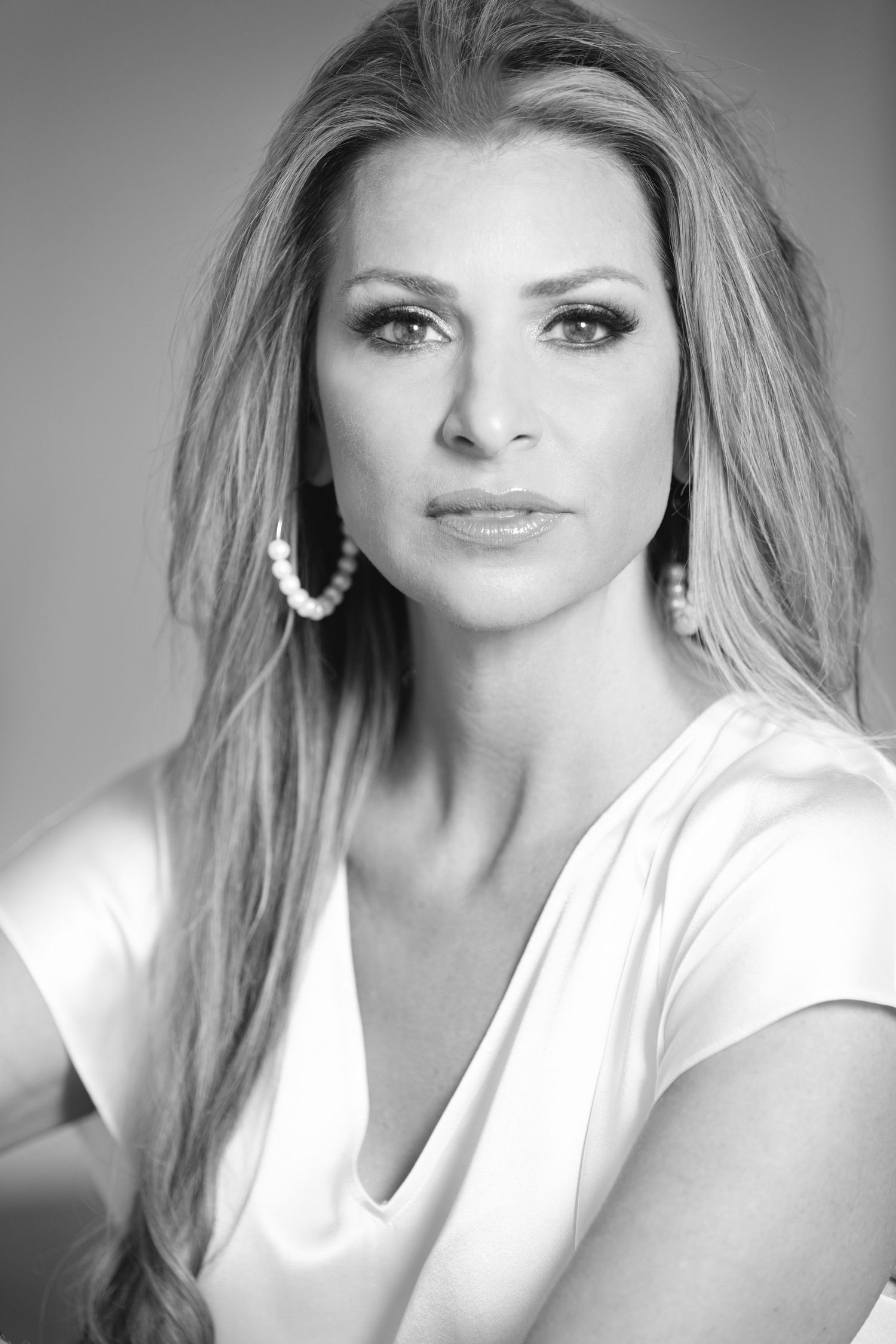 A black and white portrait sequence showing various poses and expressions in a classic glamour photography style.