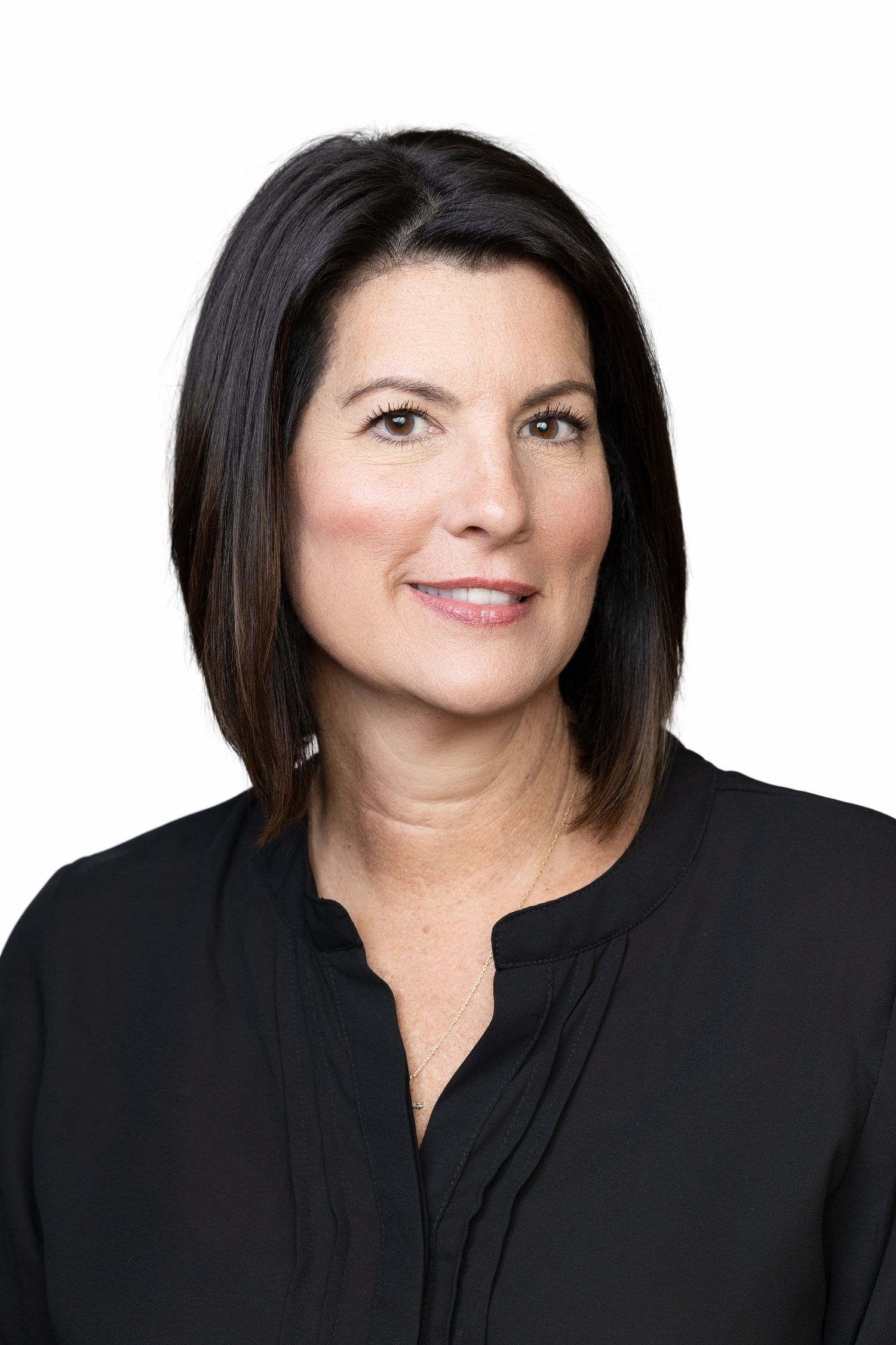 Professional headshot portrait of a person with dark hair wearing a black top against a white background.
