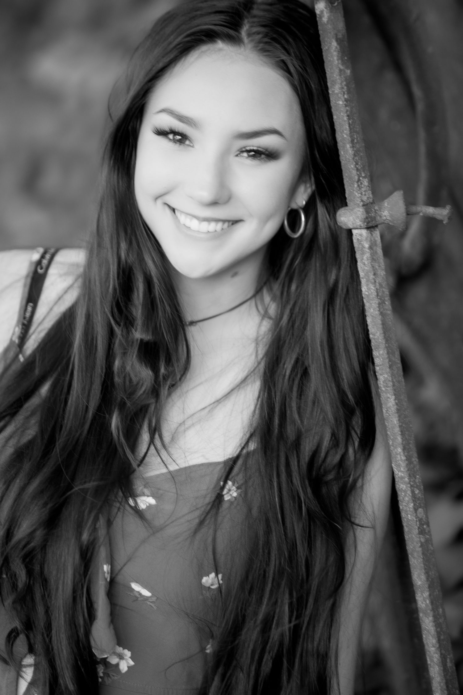 Black and white portrait series shows a young woman with long dark hair smiling against a blurred background.
