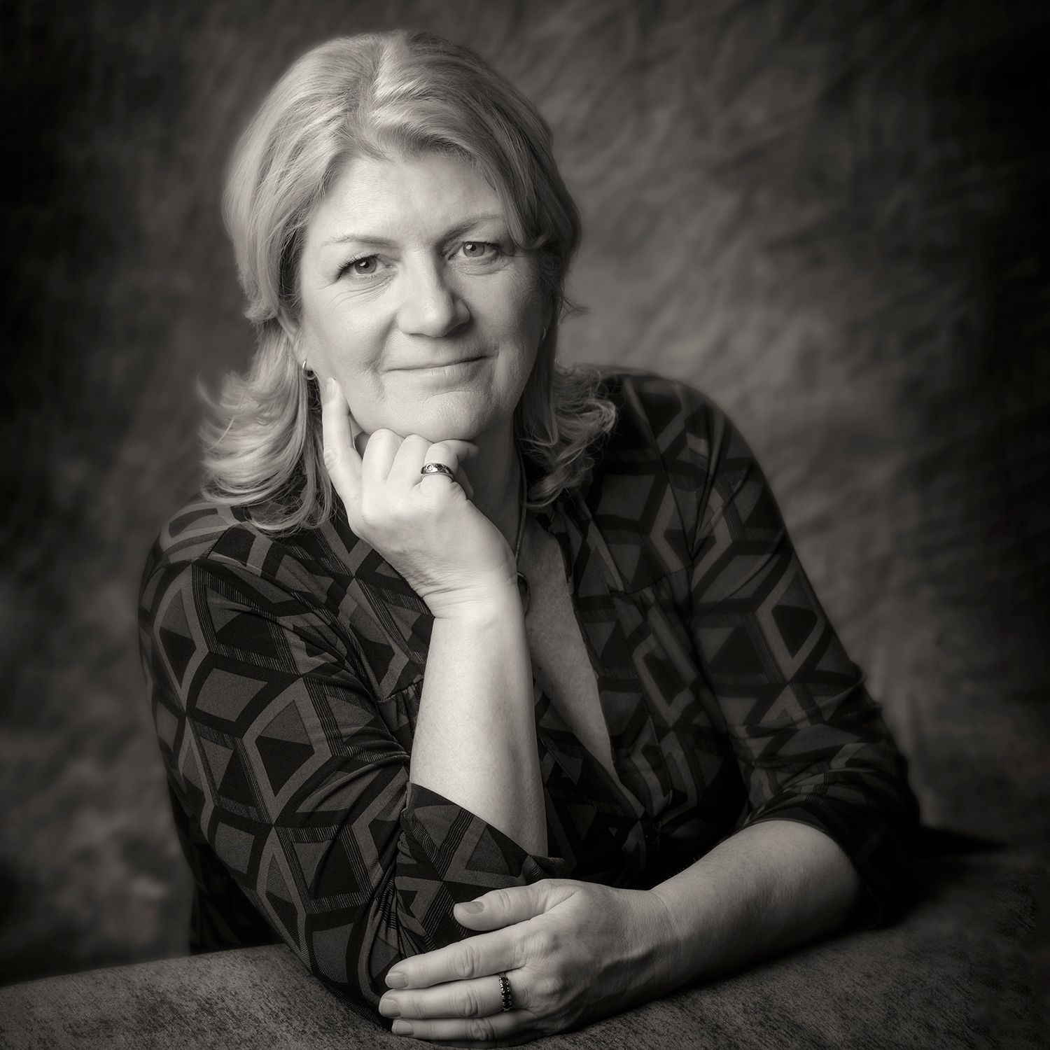 Professional black and white portrait of artist Bobbie Bush against a dark background.