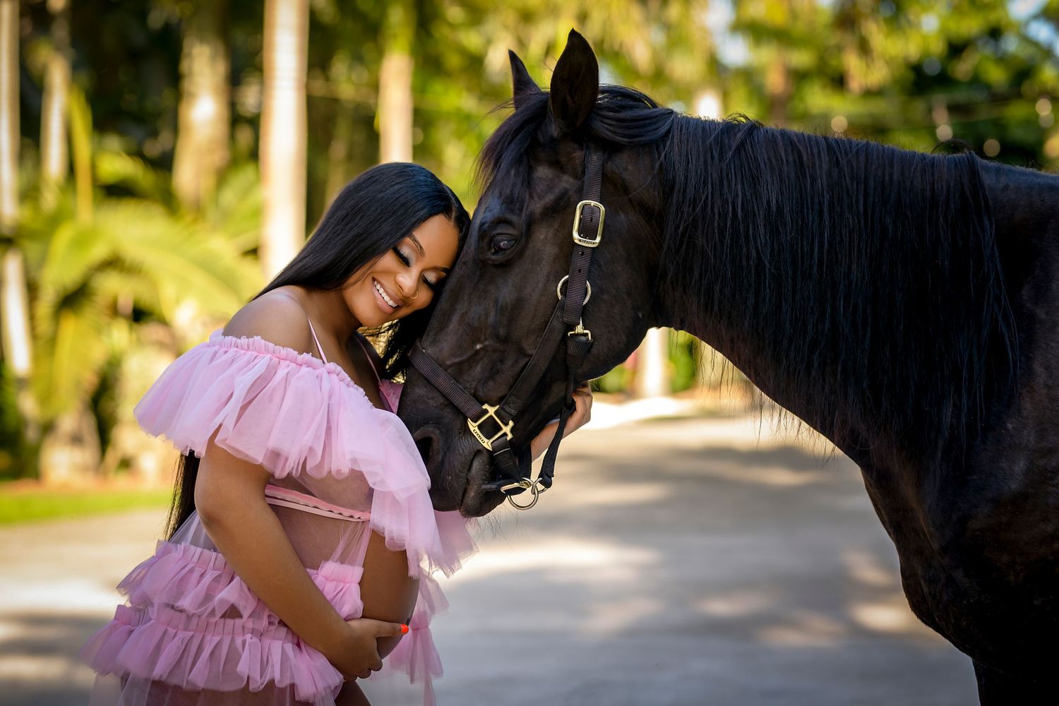A person in a pink dress interacts with a black horse in multiple outdoor photos against a natural backdrop.