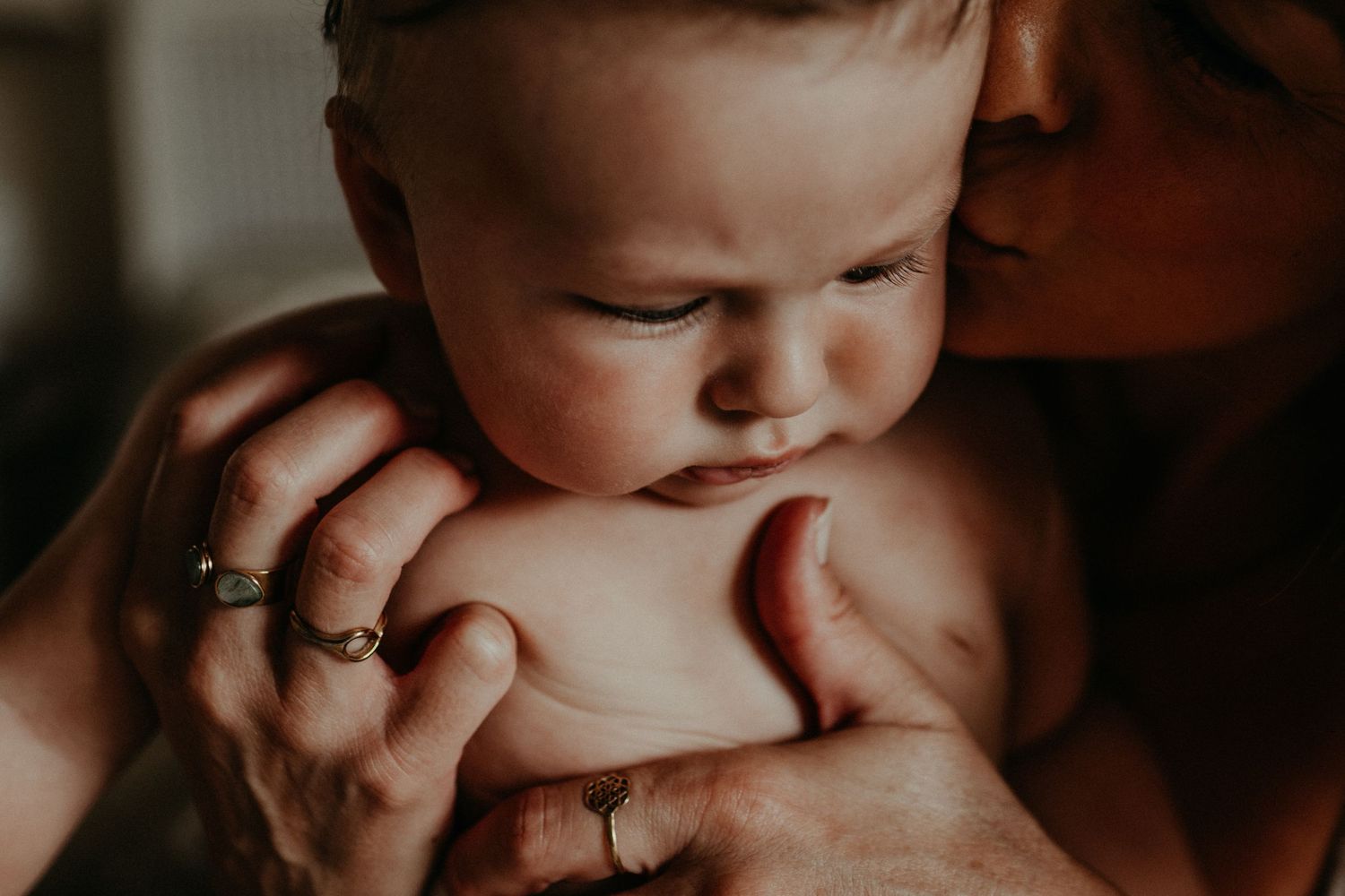Close up of a mother holding her baby during a motherhood family session in Kent