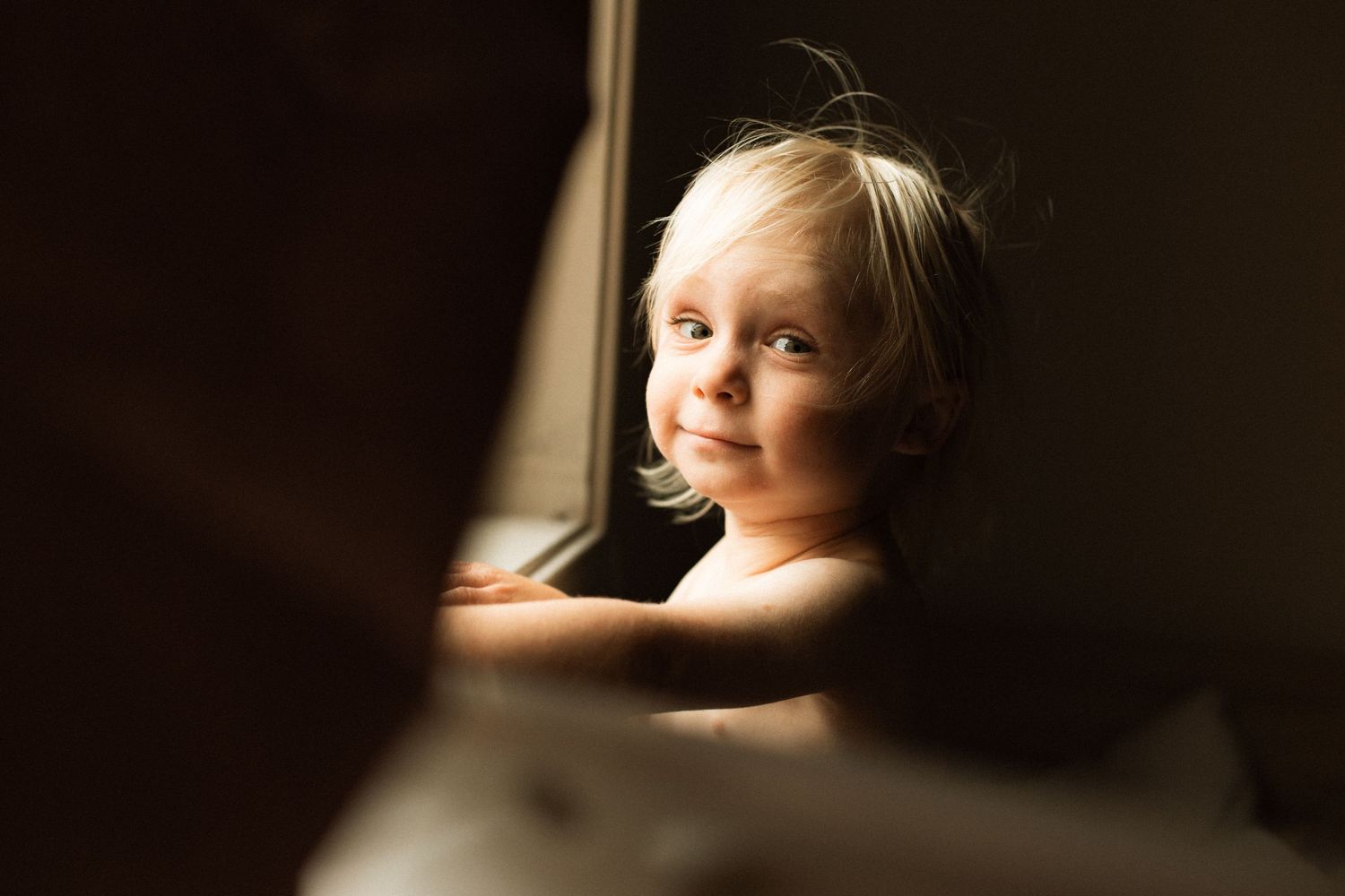Young boy in window light