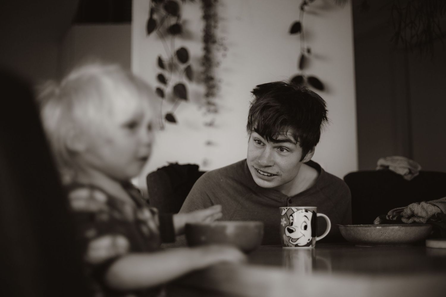 Big and little brother sitting having breakfast together