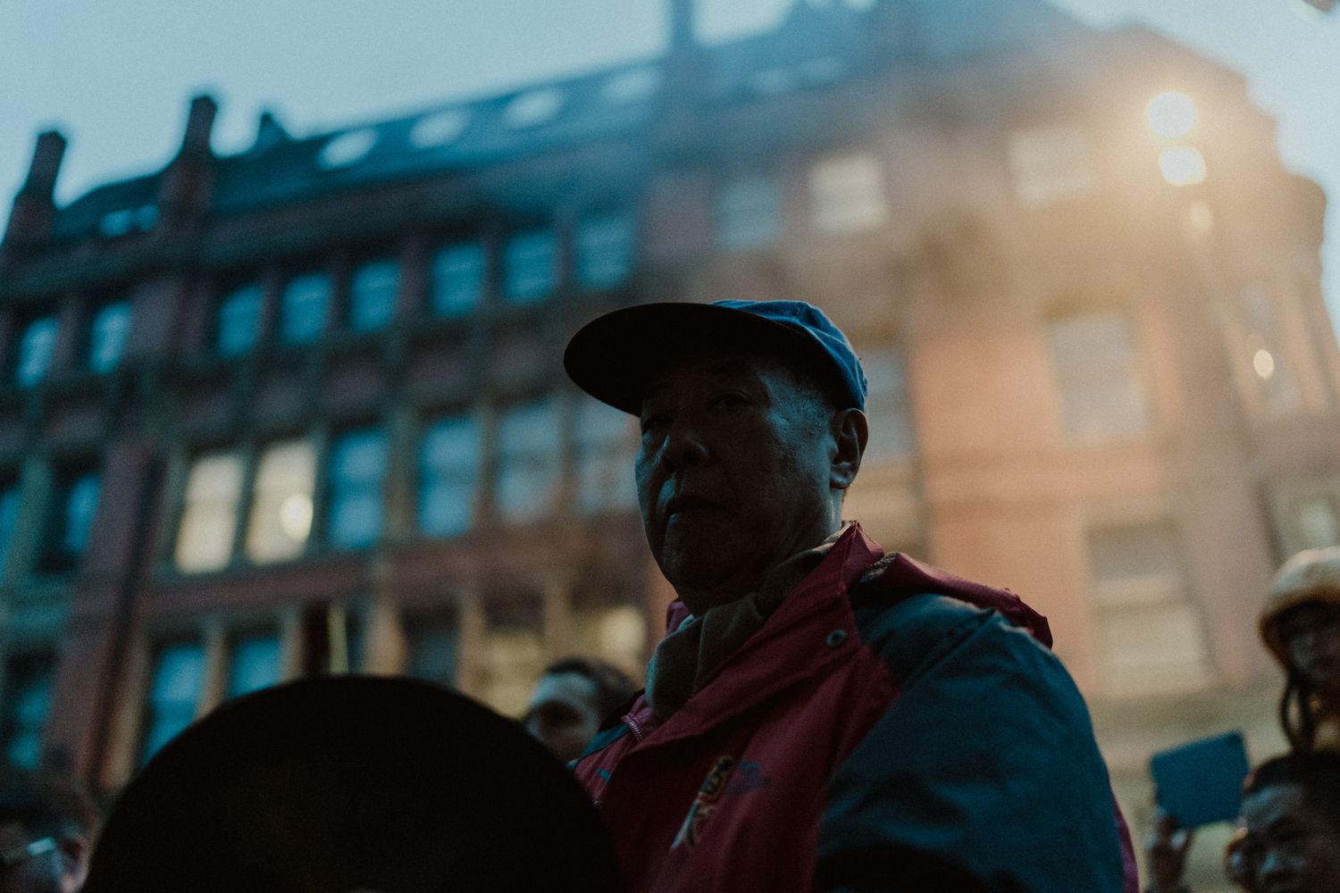 Cinematic candid portrait of a man in the city — moody light documentary wedding photography