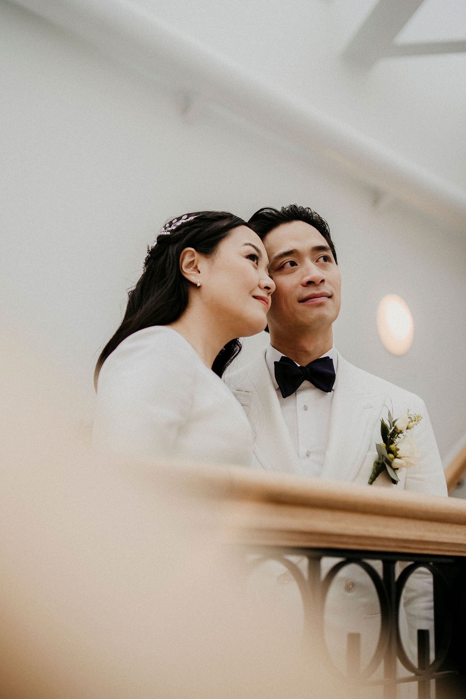 An intimate wedding portrait captured from a low angle with soft lighting.