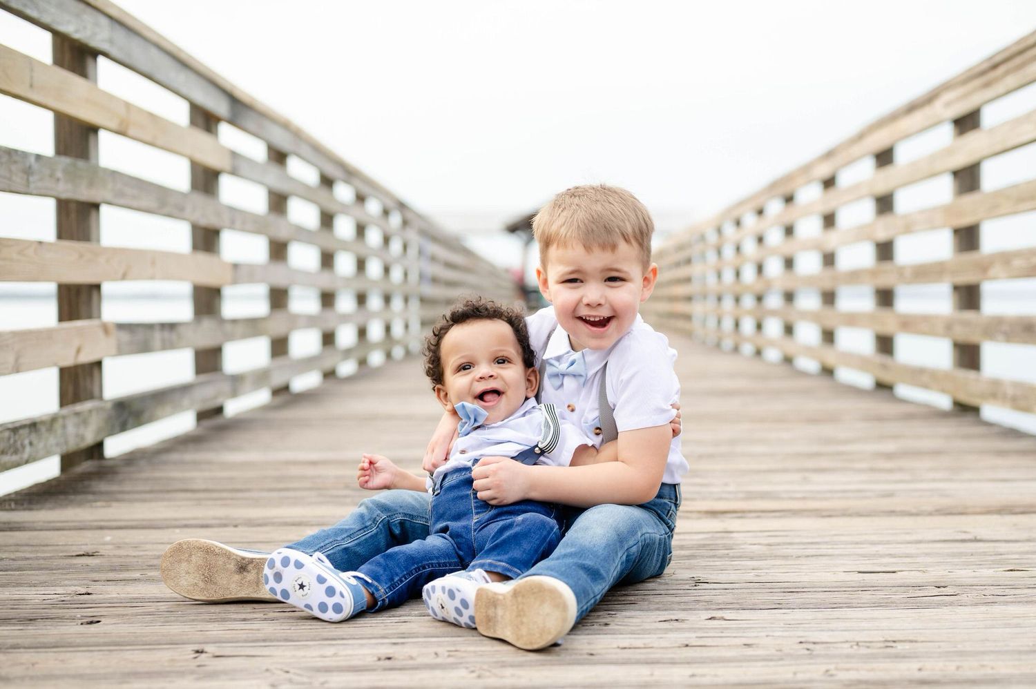 Two cute little boys hugging and smiling at Alpine Groves, one of the best locations in Jacksonville for photos