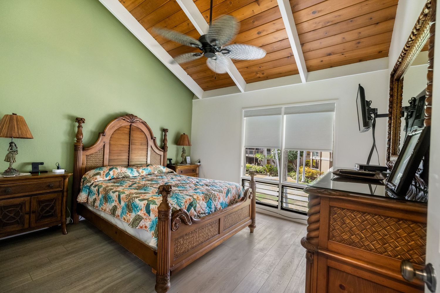 Tropical bedroom with wood ceiling, ceiling fan and woven bamboo decor.