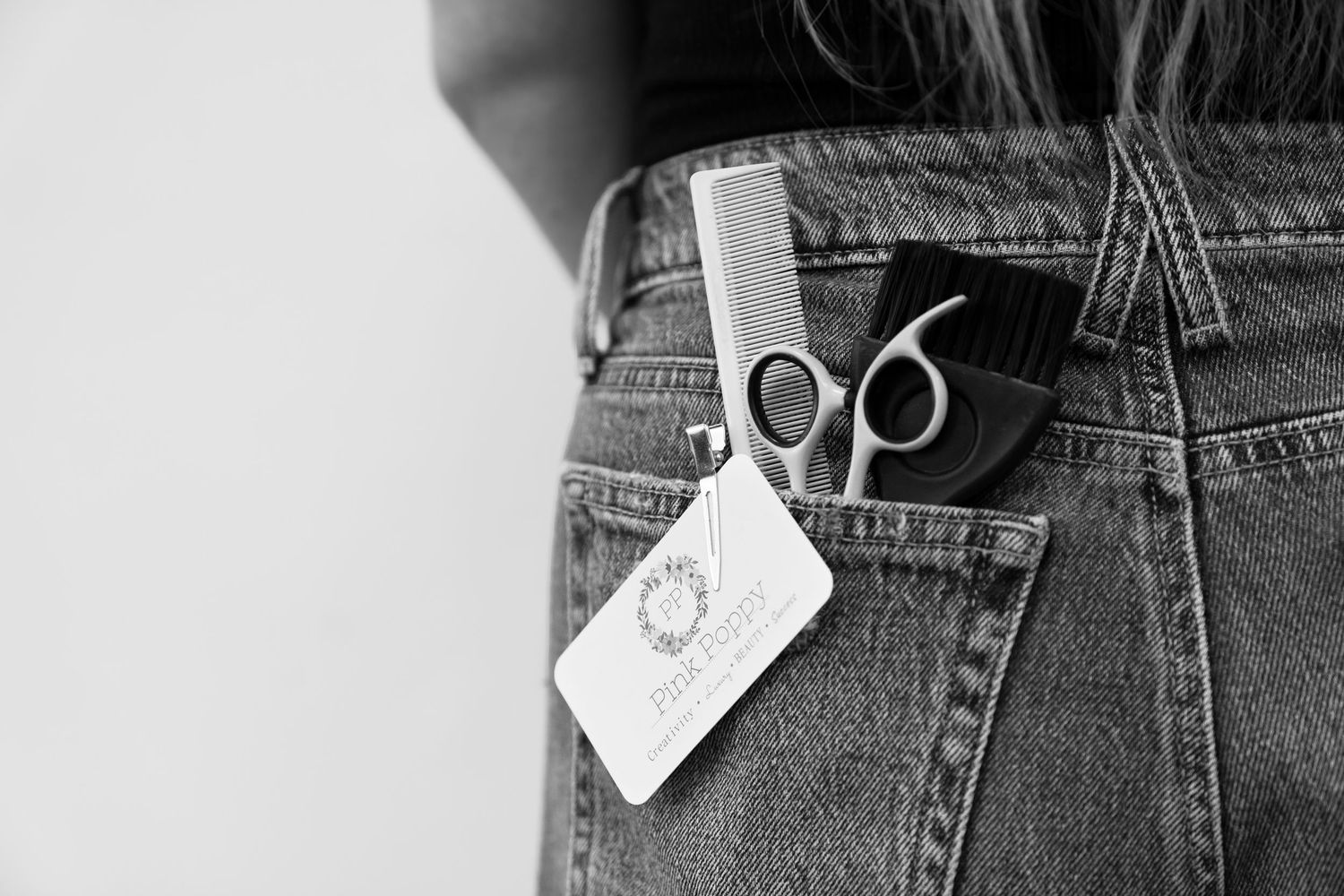 Close-up view of folded denim jeans and sale tags in a retail clothing store display.
