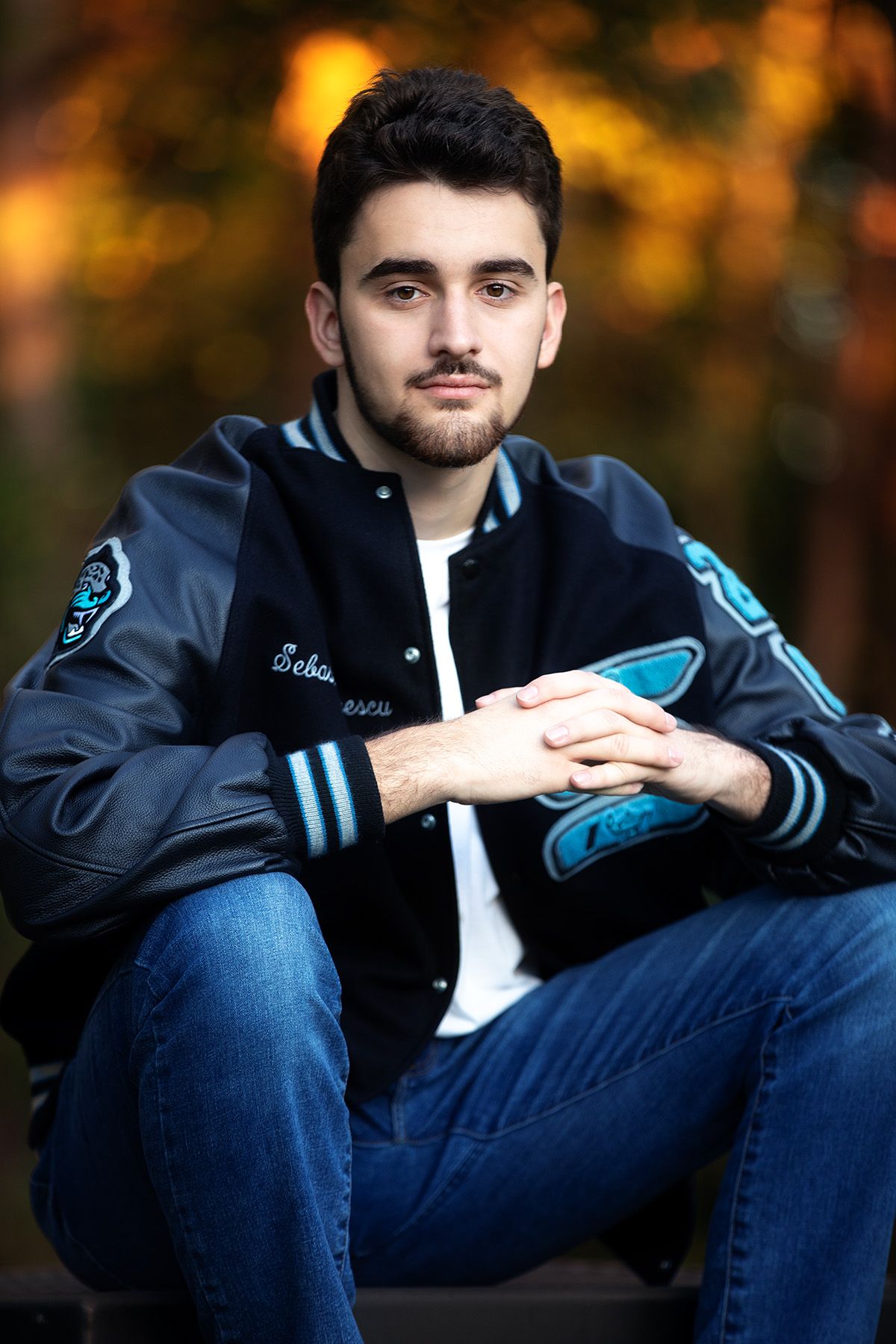 Seven progressively zooming portrait photos show someone wearing a black jacket and jeans against an autumn background.