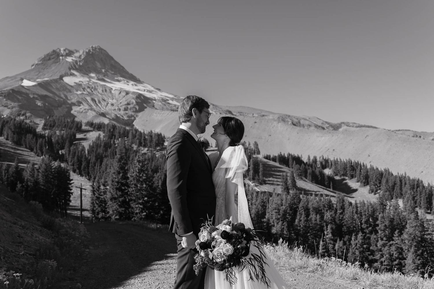 Black and white portrait with Mount Hood's snow-capped peak in the background.