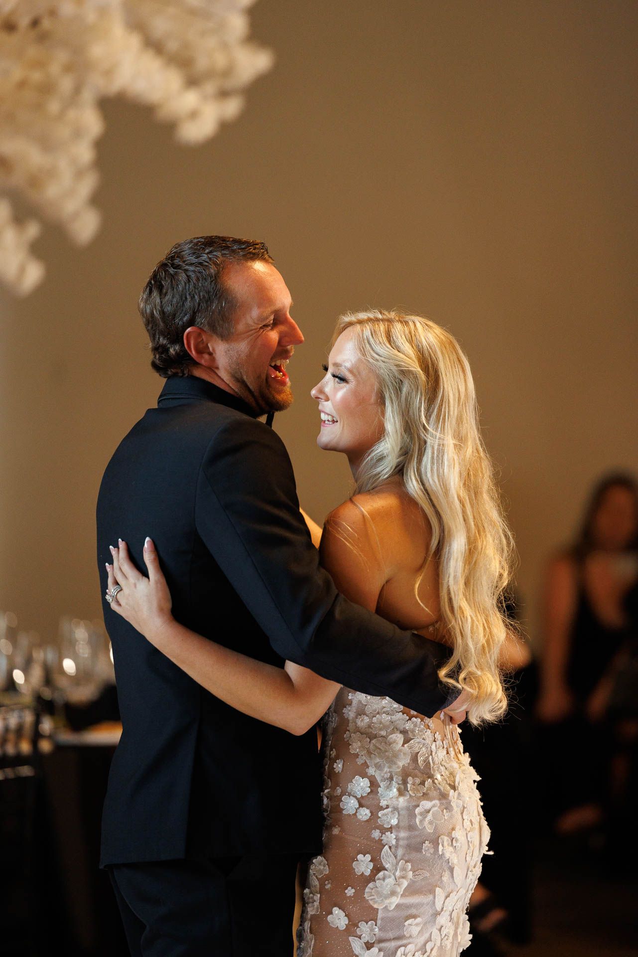A tender moment shared during a wedding dance with the couple embracing in formal attire.