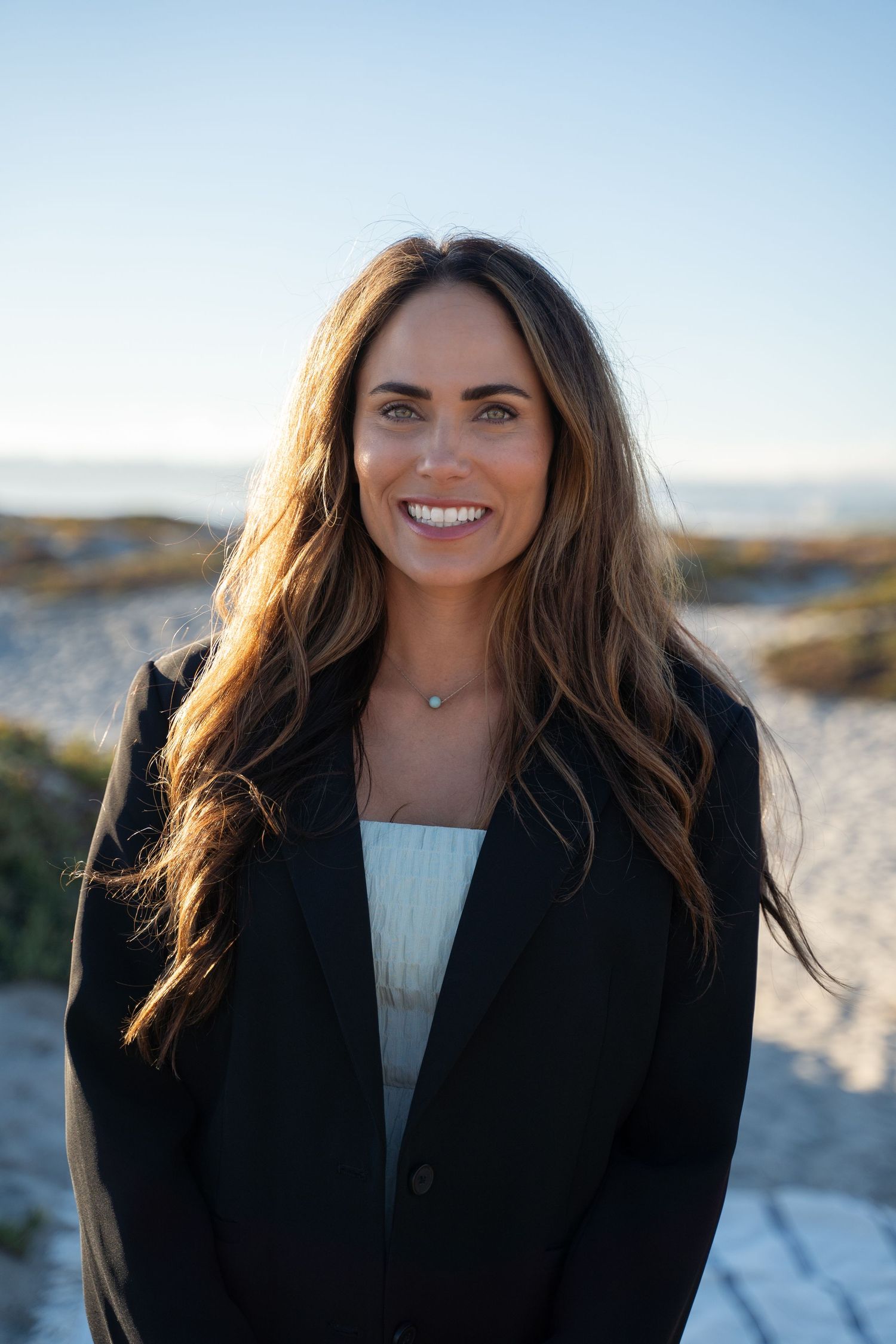 casual professional portrait at a coastal background