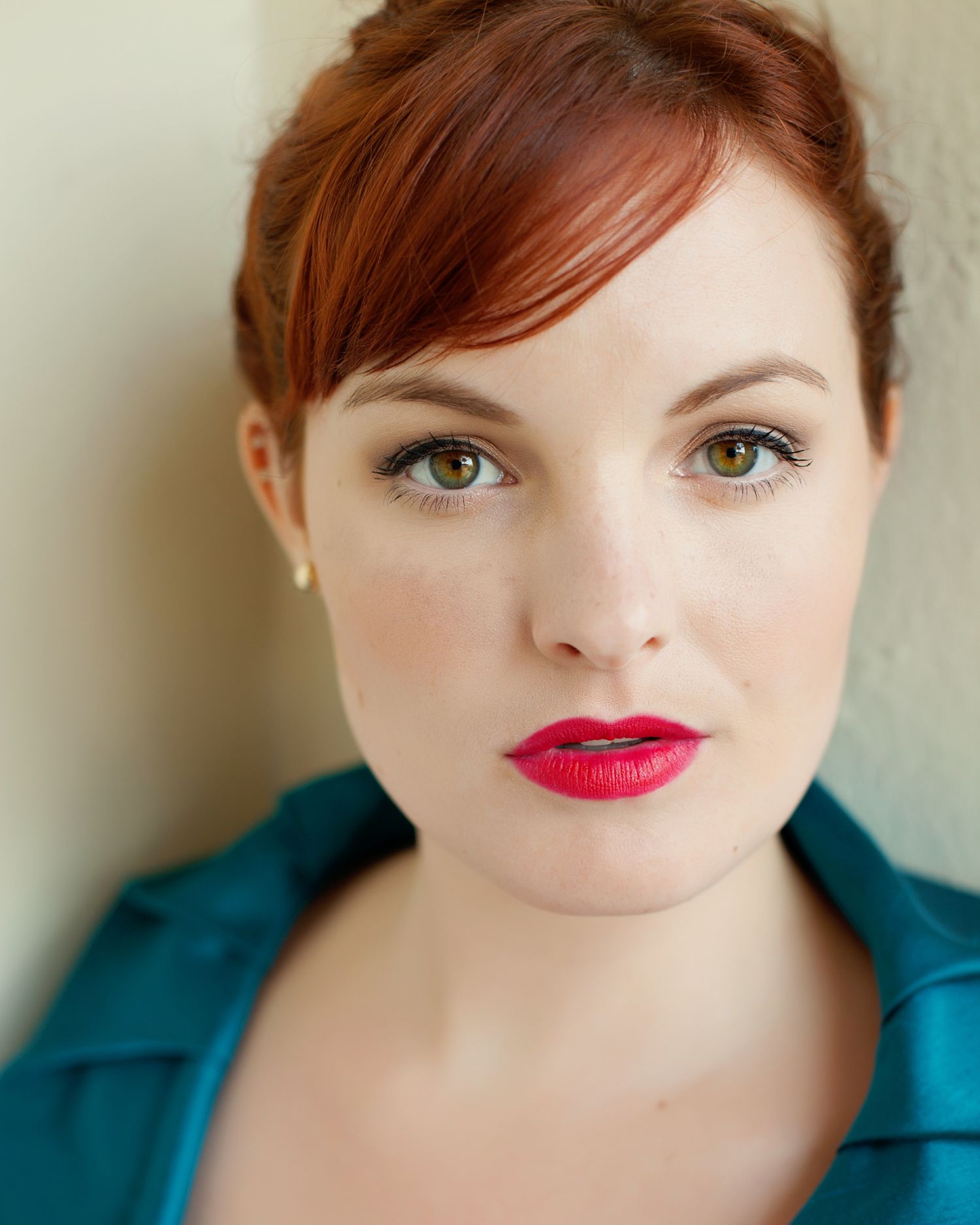 Professional outdoor portrait of a theatrical performer with neutral backdrop and natural expression