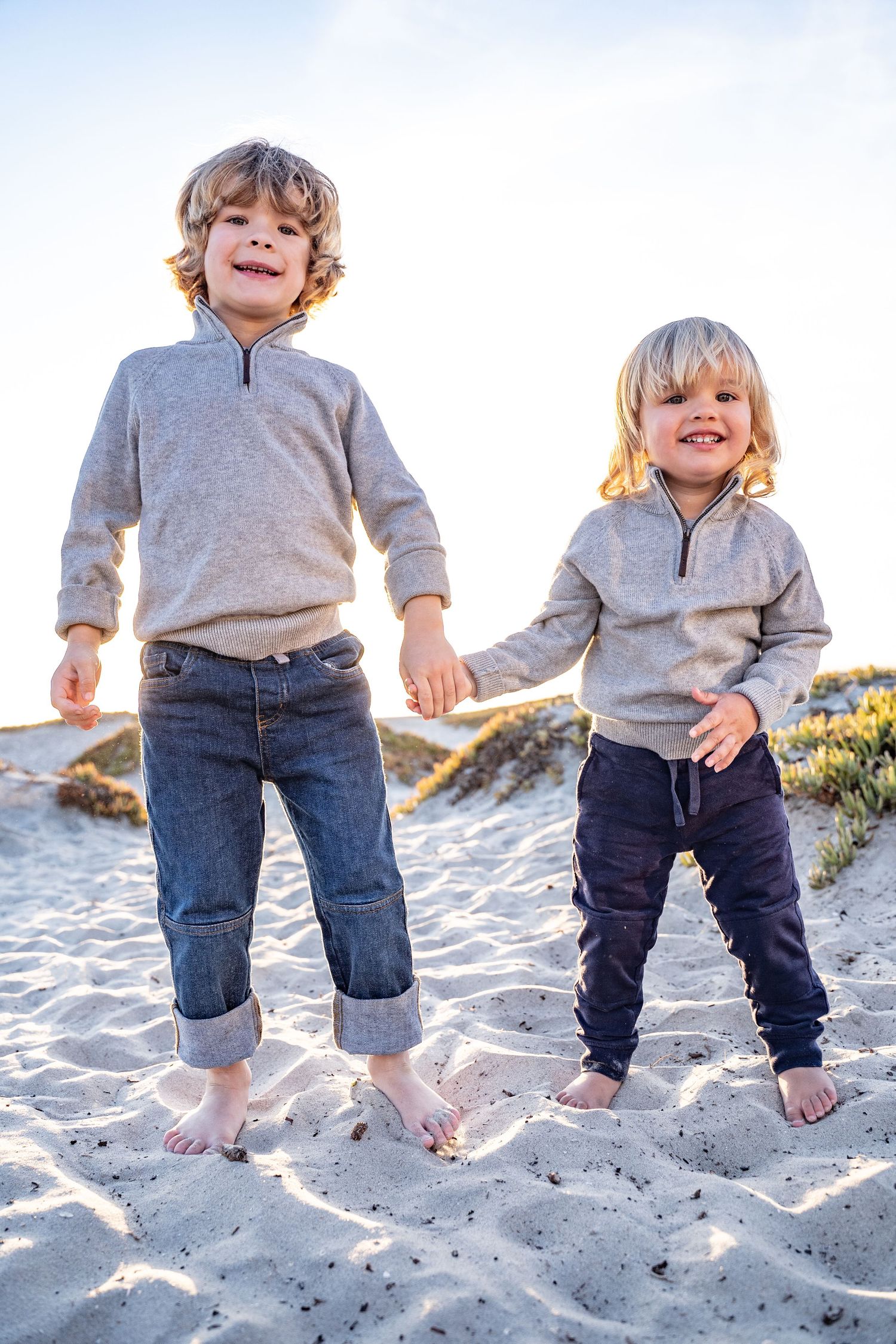 cute siblings play on the beach in southern california lifestyle shoot
