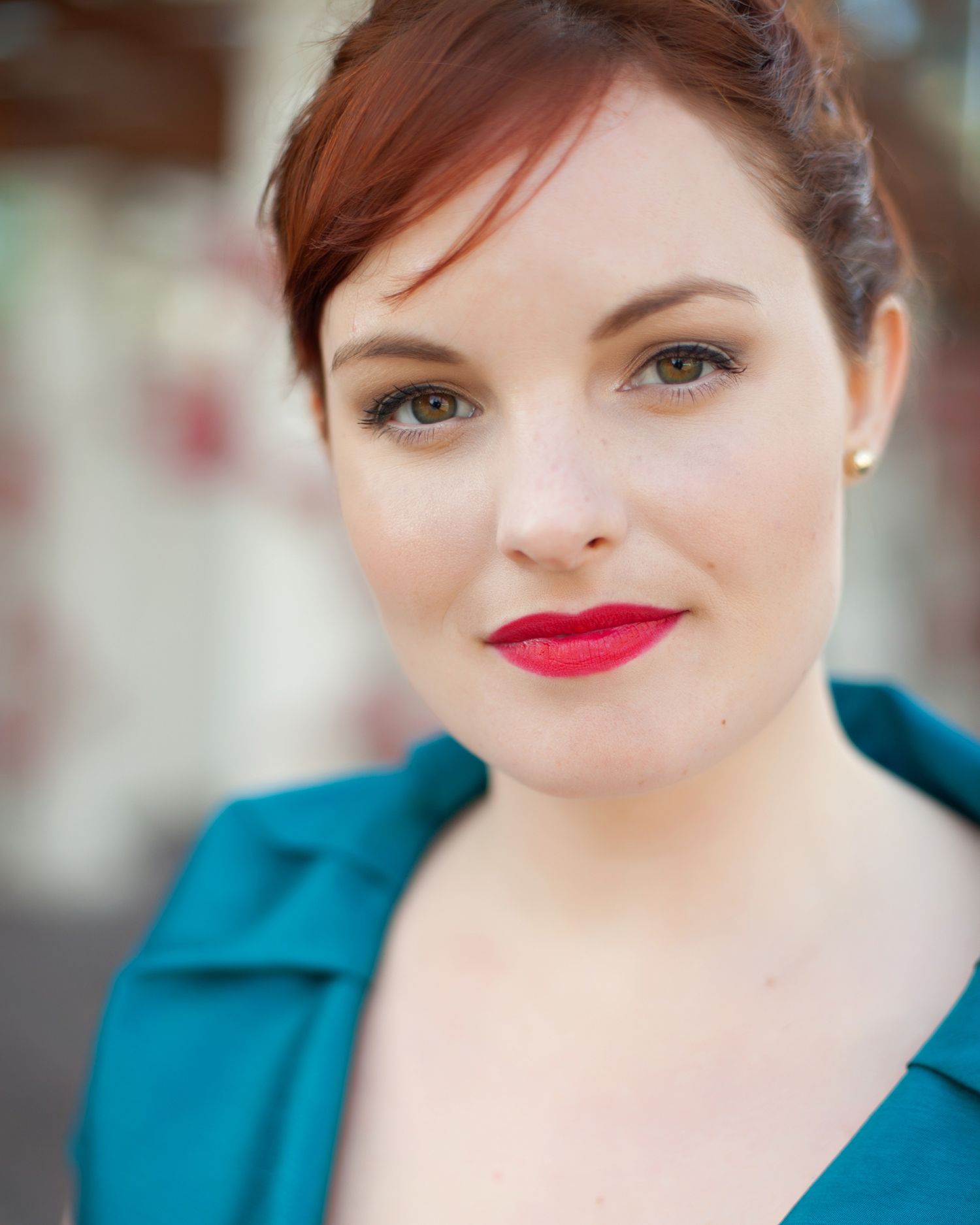 a coy smile on a beautiful red-headed actress