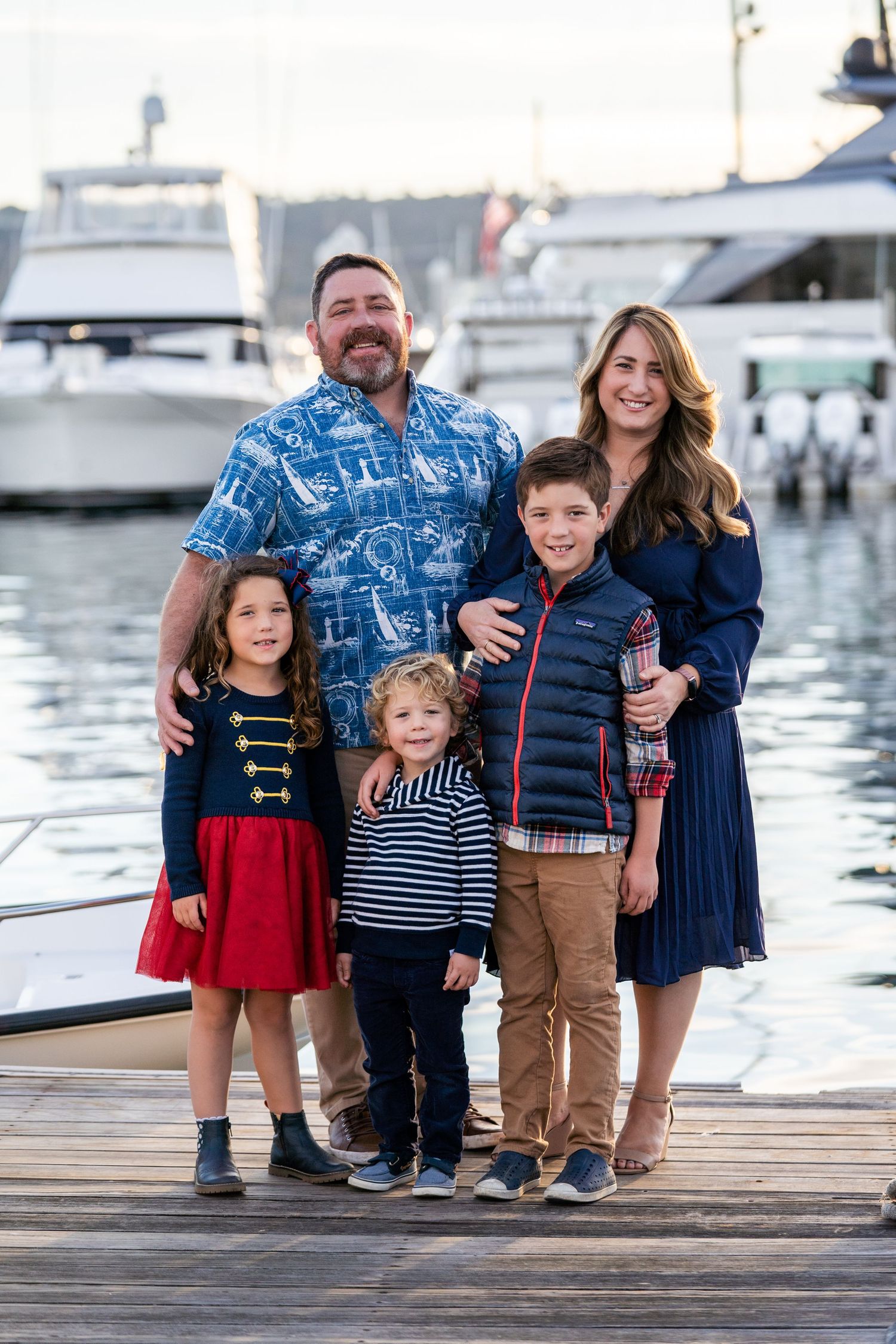 Lifestyle family portrait session on the marina docks with boats and blue water – San Diego Yacht Club setting