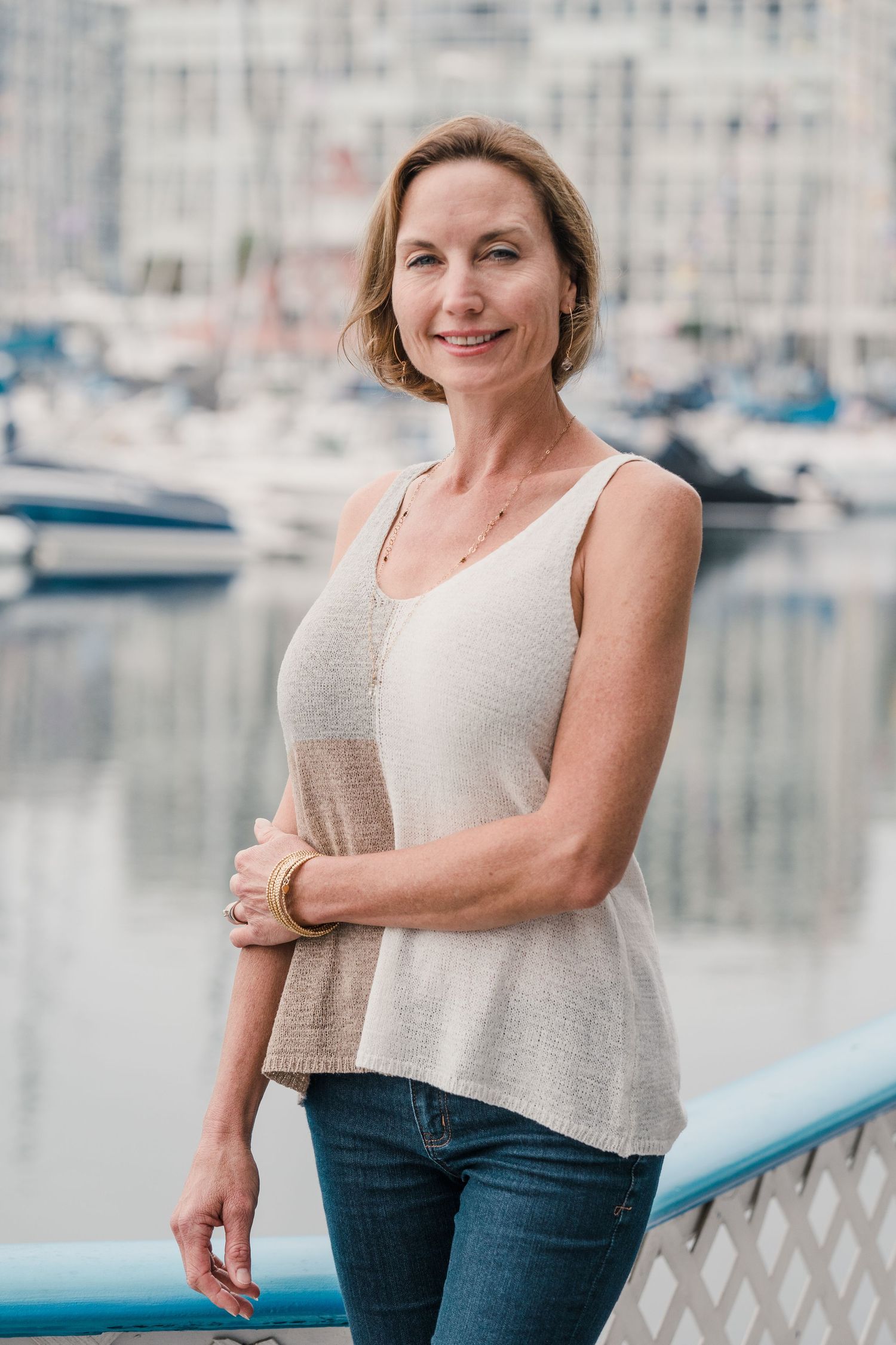 Professional headshot taken outdoors with a coastal background