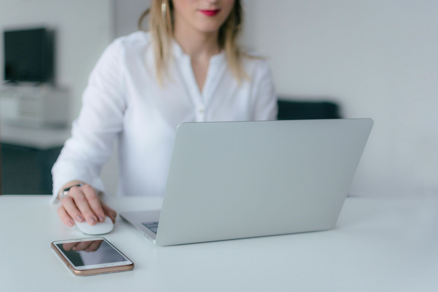 Female entrepreneur typing on her laptop during personal brand photo session – modern workspace setup