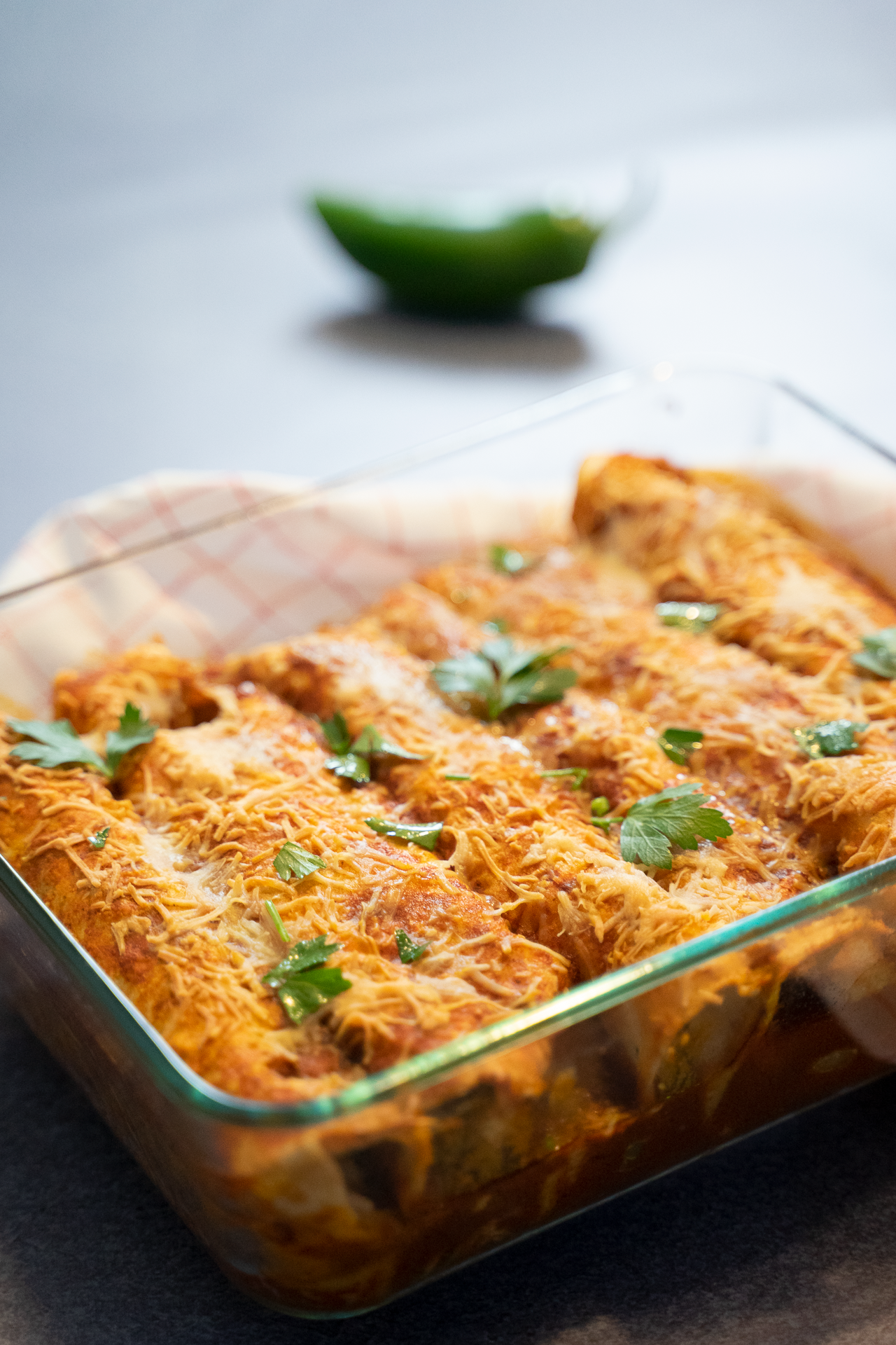 Seafood enchiladas filled with crab meat and topped with cilantro-lime crema – plated for cookbook photography