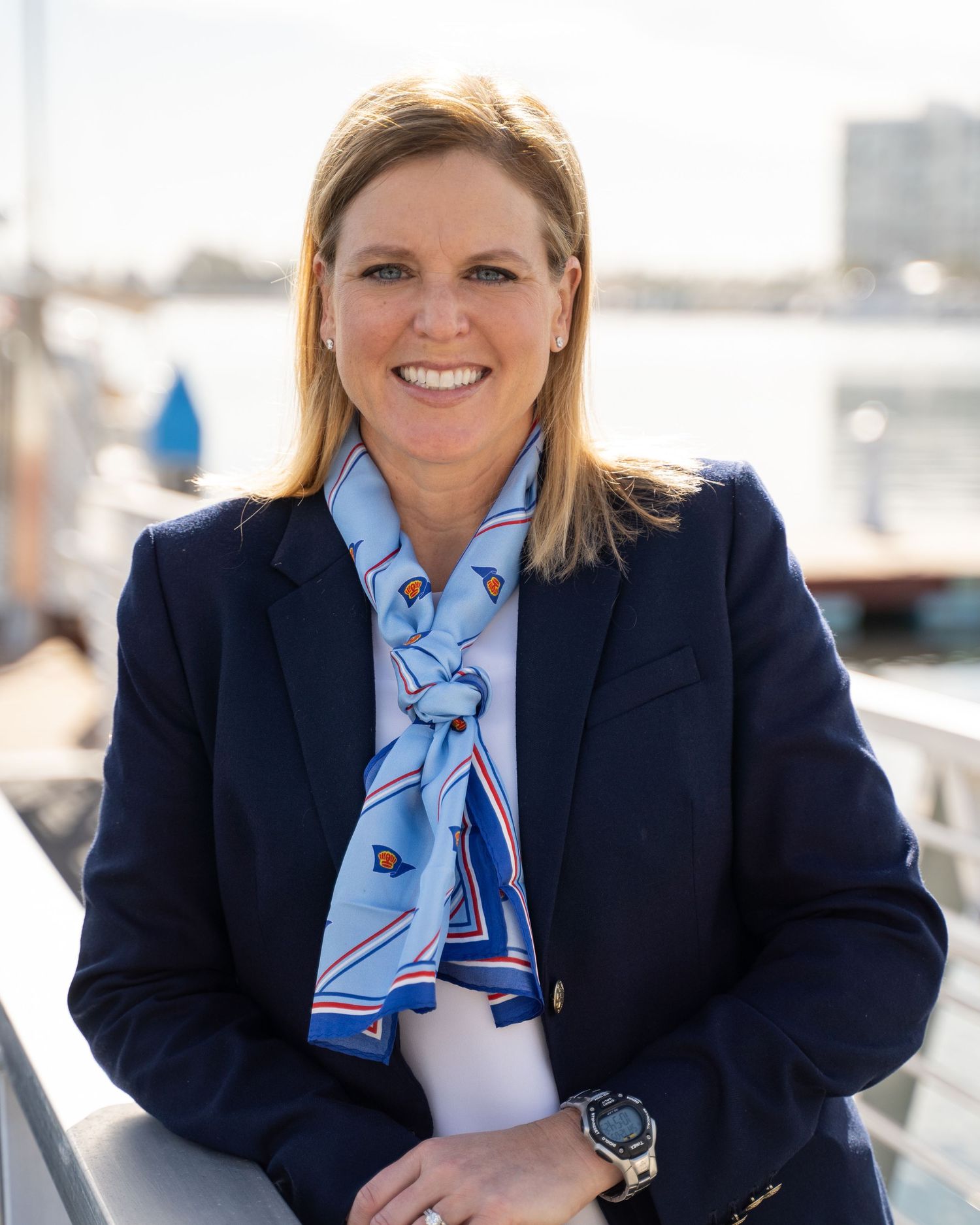 Professional headshot of Coronado Yacht Club board member with marina in the background