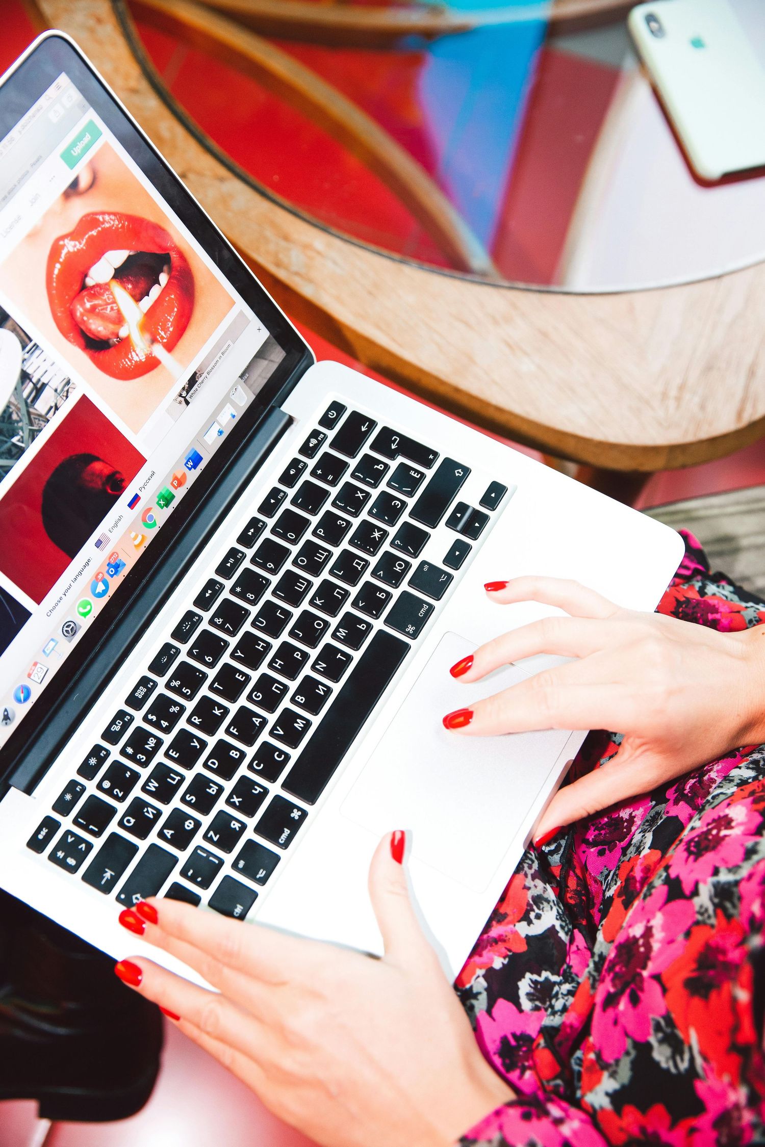San Diego brand strategist working on MacBook Pro, over-the-shoulder photo of woman with red nails developing brand messaging at Dolce Vita