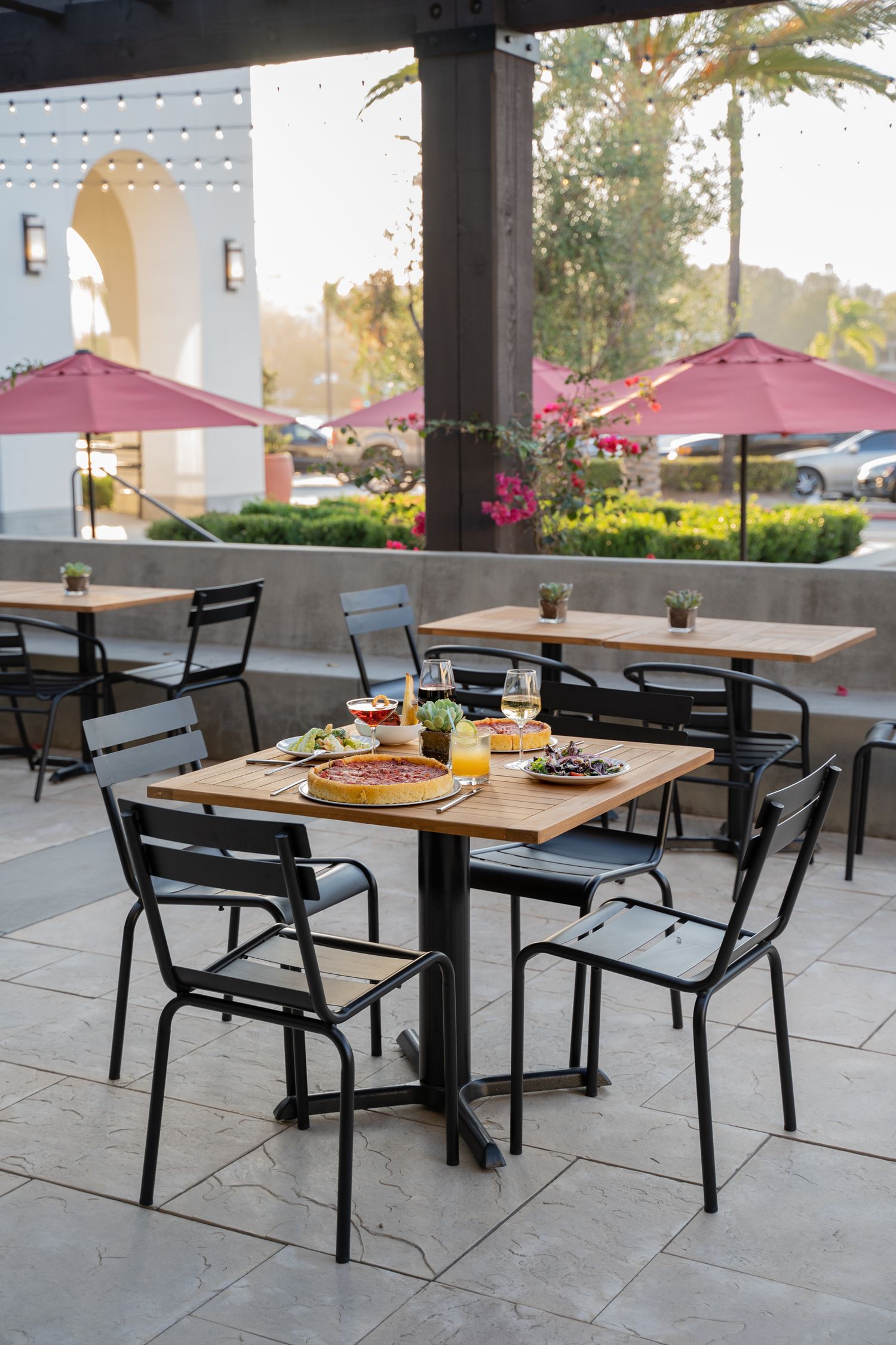 Outdoor patio dining area with twinkle lights at dusk