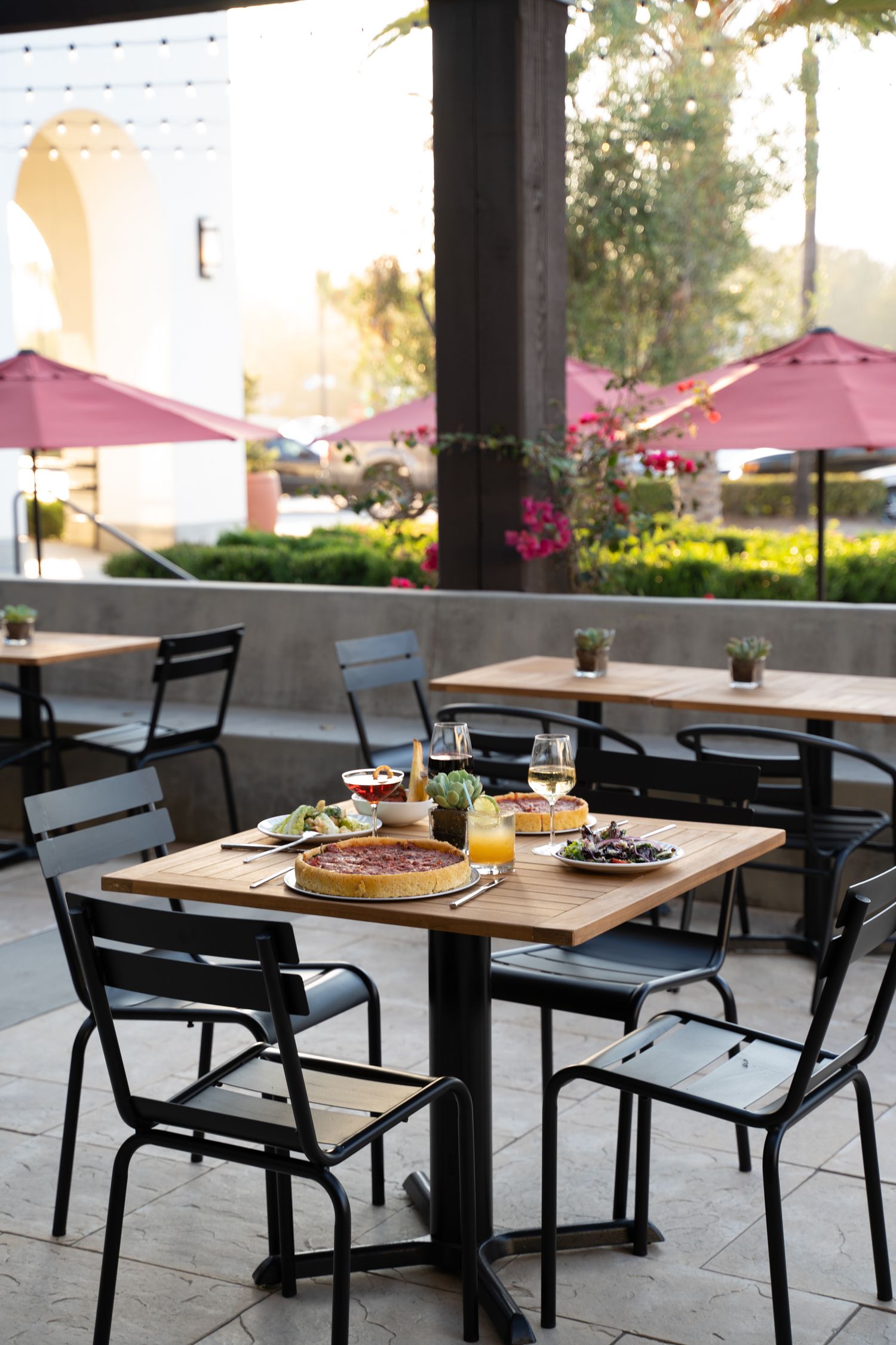 Intimate outdoor dining space illuminated by café string lights – restaurant brand photography at golden hour