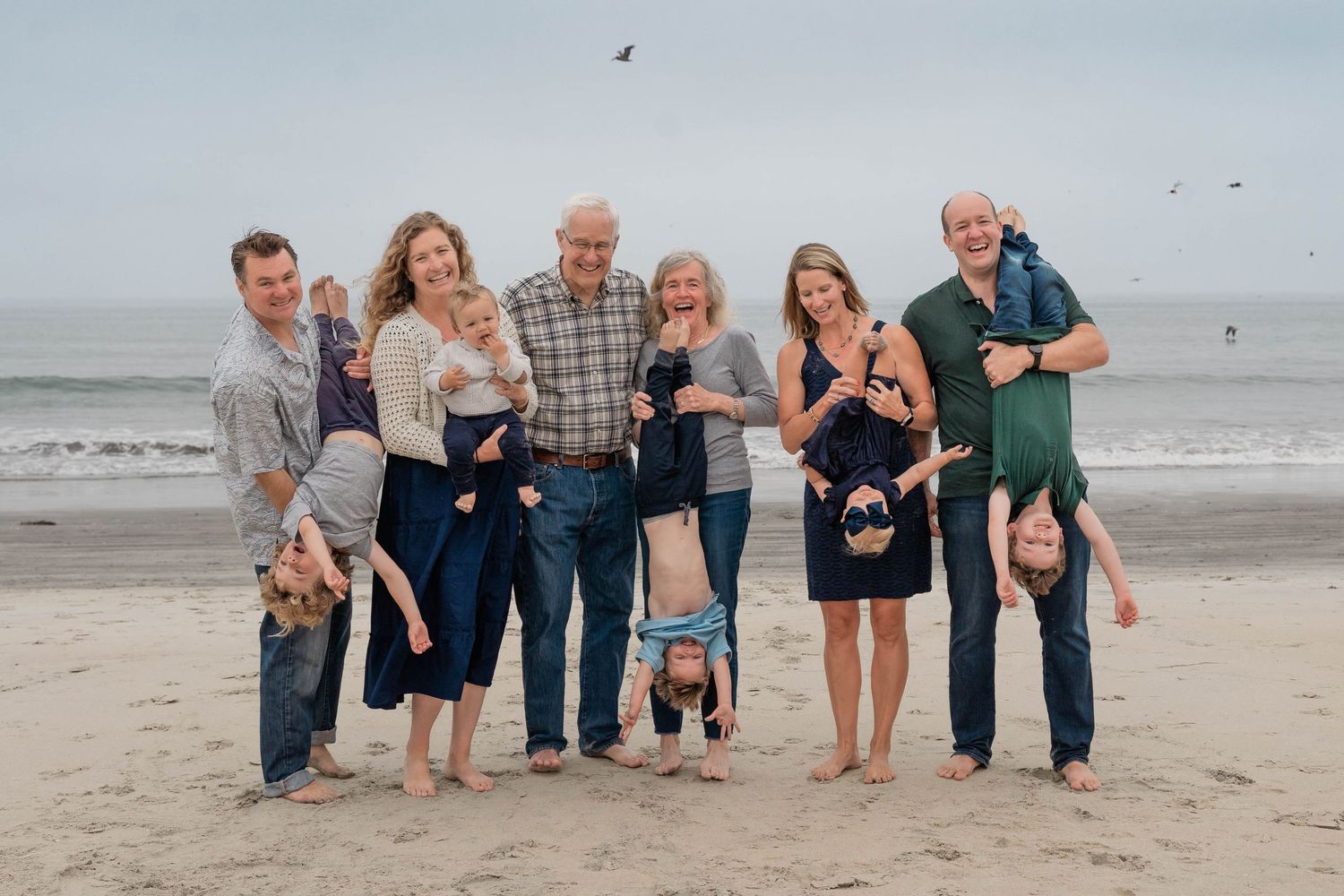 Grandparents, parents, and children sharing a joyful moment on the beach – natural light multigenerational portrait