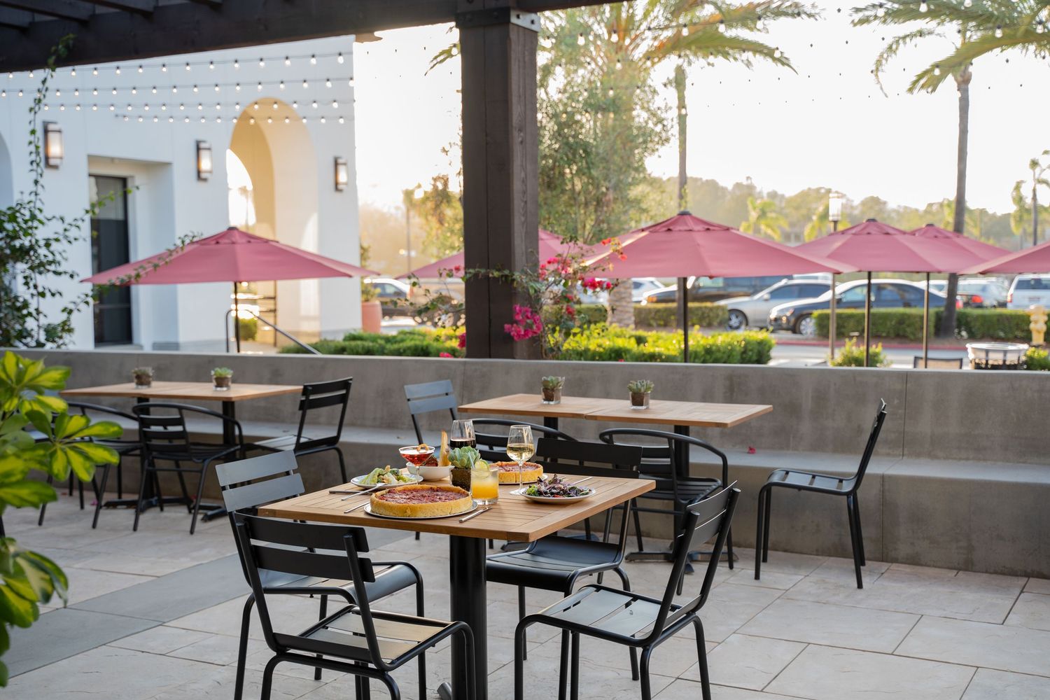 Pizzeria’s cozy outdoor seating with string lights and rustic tables – warm evening ambiance photo
