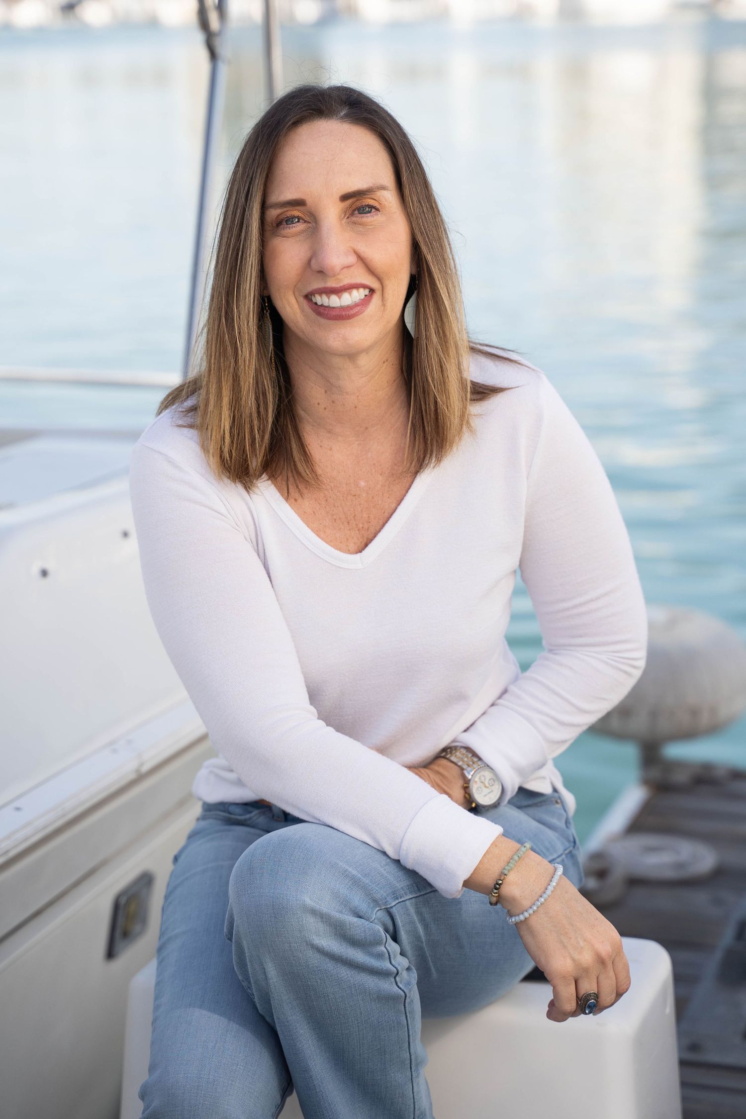 Coastal headshot with ocean tones and relaxed business-casual styling – ideal for website or LinkedIn