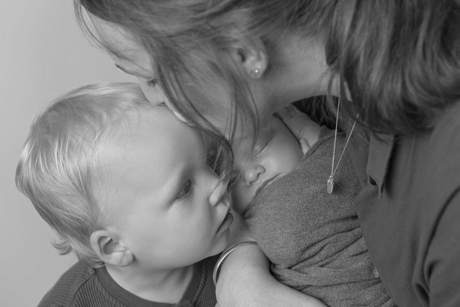 An intimate black and white portrait capturing a nurturing moment.