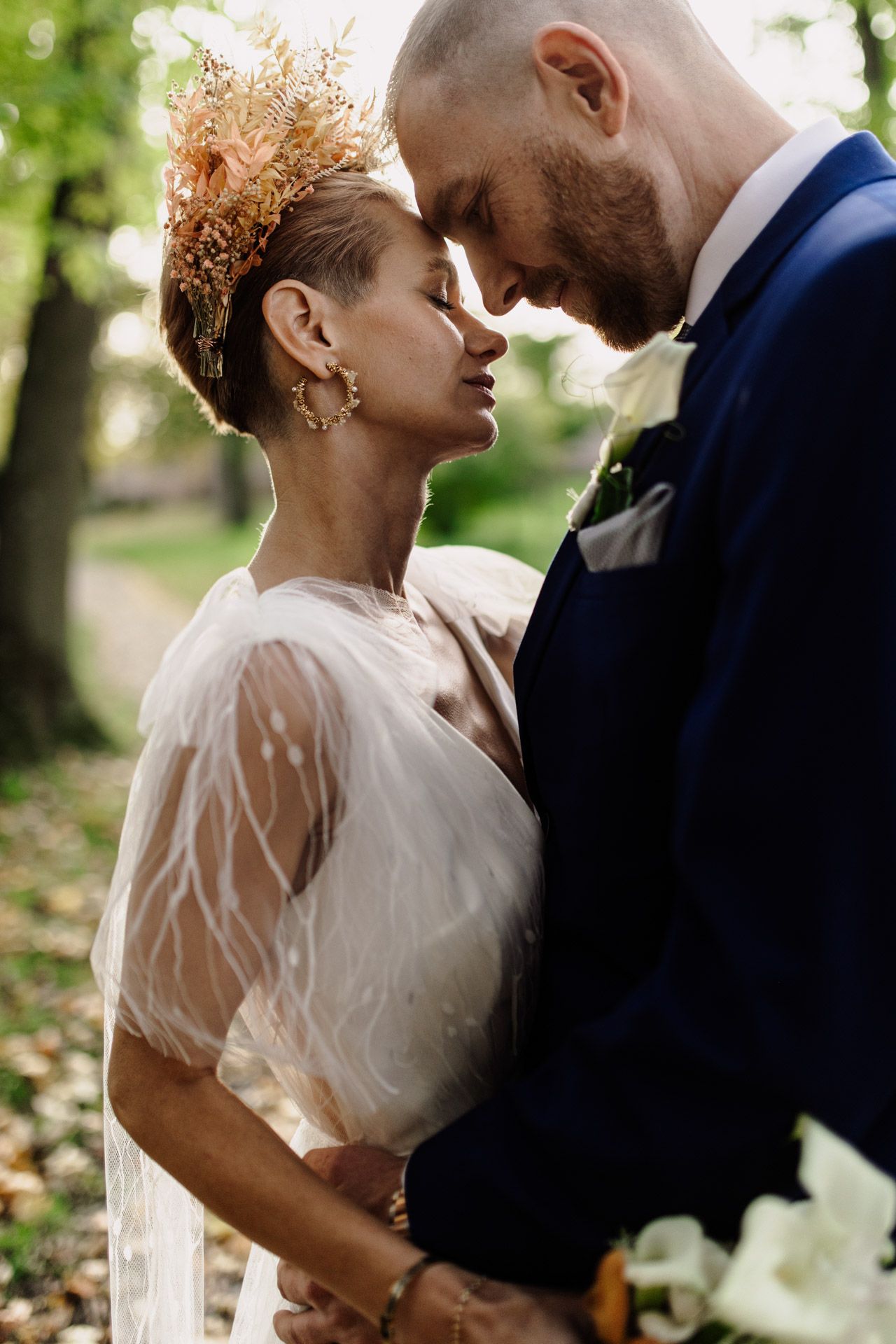 Intimate wedding moment captured outdoors with vintage-inspired styling and natural lighting.