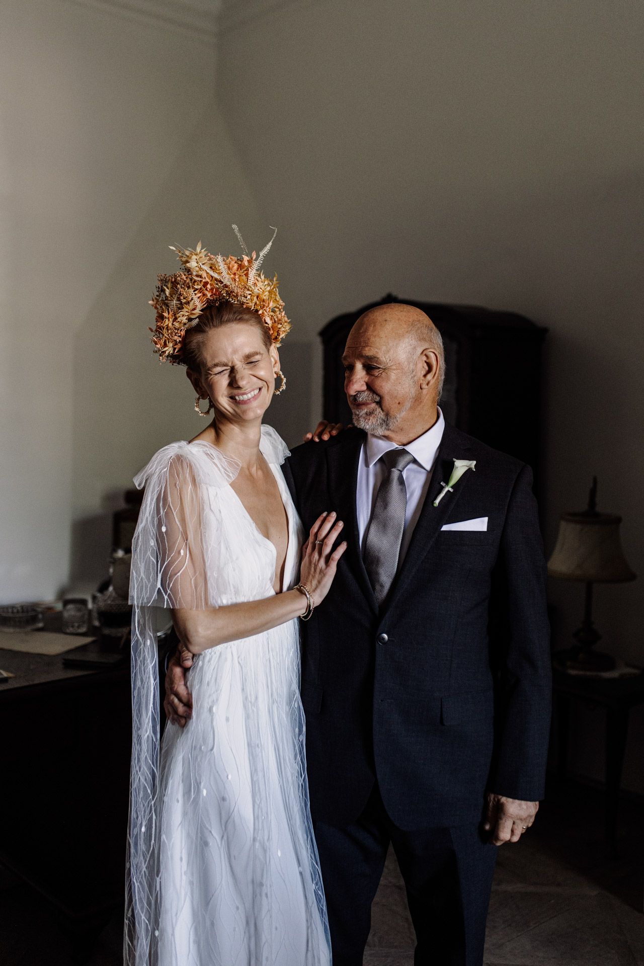 Wedding couple sharing a tender moment in a vintage-style interior.