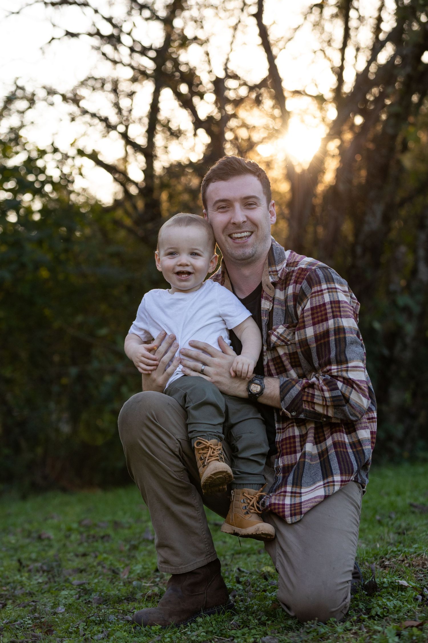 Parent and toddler share a joyful moment together in an outdoor setting at sunset.